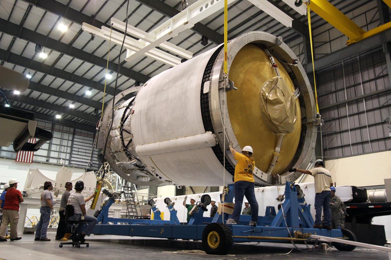 CAPE CANAVERAL, Fla. – Workers position the second stage of a Delta IV onto a mobile work stand in the Horizontal Integration Facility at Launch Complex 37 on Cape Canaveral Air Force Station in Florida. This United Launch Alliance Delta IV rocket is the vehicle slated to launch GOES-P, the latest Geostationary Operational Environmental Satellite developed by NASA for the National Oceanic and Atmospheric Administration, or NOAA. Processing of the Delta IV is on track for launch, targeted for March 4, 2010. For information on GOES-P, visit http://goespoes.gsfc.nasa.gov/goes/spacecraft/n_p_spacecraft.html. Photo credit: NASA/Jack Pfaller