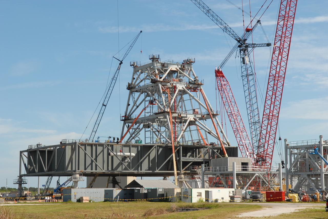 CAPE CANAVERAL, Fla. – At NASA's Kennedy Space Center in Florida, a new mobile launcher, or ML, under construction to support the Constellation Program is surrounded by cranes. The ML's tower will have multiple platforms for personnel access and be approximately 345 feet tall. The launcher is being built at the mobile launcher park site area located north of Kennedy's Vehicle Assembly Building to support the Ares I rocket. The ML will provide a base to launch the Ares I, designed to transport the Orion crew exploration vehicle, its crew and cargo to low Earth orbit. The base is being made lighter than space shuttle mobile launcher platforms so the crawler-transporter can pick up the heavier load of the tower and taller rocket. For information on the Ares I, visit http://www.nasa.gov/ares. Photo credit: NASA/Jim Grossmann