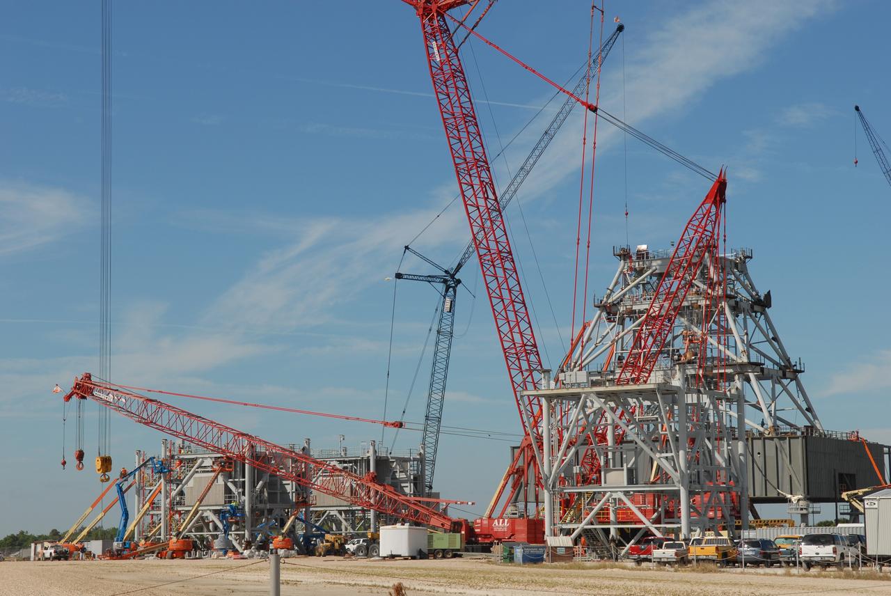 CAPE CANAVERAL, Fla. – At NASA's Kennedy Space Center in Florida, a bevy of cranes obscures the view of the tower on a new mobile launcher, or ML, under construction to support the Constellation Program. The ML's tower will have multiple platforms for personnel access and be approximately 345 feet tall. The launcher is being built at the mobile launcher park site area located north of Kennedy's Vehicle Assembly Building to support the Ares I rocket. The ML will provide a base to launch the Ares I, designed to transport the Orion crew exploration vehicle, its crew and cargo to low Earth orbit. The base is being made lighter than space shuttle mobile launcher platforms so the crawler-transporter can pick up the heavier load of the tower and taller rocket. For information on the Ares I, visit http://www.nasa.gov/ares. Photo credit: NASA/Jim Grossmann