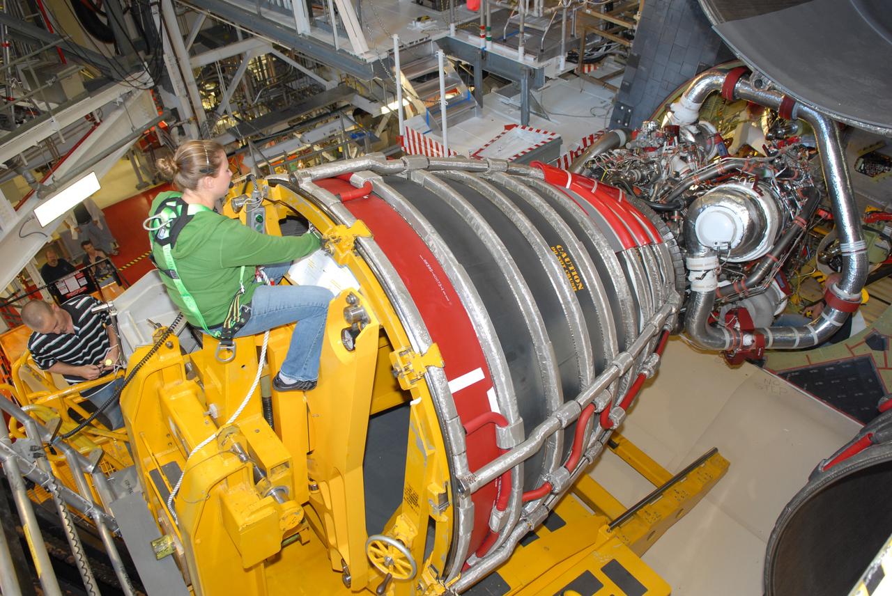 CAPE CANAVERAL, Fla. – A Pratt & Whitney Rocketdyne technician carefully maneuvers a space shuttle main engine into position on space shuttle Endeavour in Orbiter Processing Facility Bay 2 at NASA's Kennedy Space Center in Florida. The engine will fly on the shuttle's STS-130 mission to the International Space Station. Even though this engine weighs one-seventh as much as a locomotive engine, its high-pressure fuel pump alone delivers as much horsepower as 28 locomotives, while its high-pressure oxidizer pump delivers the equivalent horsepower of an additional 11 locomotives. The maximum equivalent horsepower developed by the shuttle's three main engines is more than 37 million horsepower. Endeavour is targeted to launch Feb. 4, 2010. Photo credit: NASA/Jim Grossmann