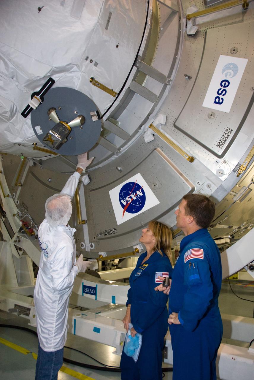 CAPE CANAVERAL, Fla. – In the Space Station Processing Facility at NASA's Kennedy Space Center in Florida, STS-130 Mission Specialist Kathryn "Kay" Hire, middle, and Pilot Terry Virts Jr., right, receive familiarization training on the cupola from a flight crew representative from Thales Alenia Space during their crew equipment interface test.  The cupola, a unique work station with six windows on its sides and one on top, is attached to one end of the Tranquility node.    Tranquility, the payload for the STS-130 mission, is a pressurized module that will provide room for many of the International Space Station's life support systems. The module was built for the European Space Agency by Thales Alenia Space in Turin, Italy. The cupola resembles a circular bay window that will provide a vastly improved view of the station's exterior. Just under 10 feet in diameter, the module will accommodate two crew members and portable workstations that can control station and robotic activities. The multi-directional view will allow the crew to monitor spacewalks and docking operations, as well as provide a spectacular view of Earth and other celestial objects. Endeavour is targeted to launch Feb. 4, 2010. Photo credit: NASA/Kim Shiflett