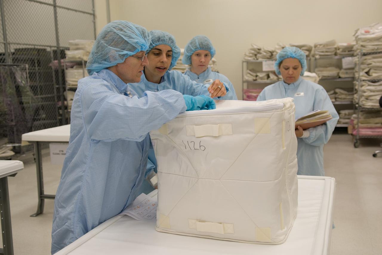 CAPE CANAVERAL, Fla. – In the Space Station Processing Facility at NASA's Kennedy Space Center in Florida, STS-130 Mission Specialist Kathryn "Kay" Hire, at left, participates in a bench review, standard familiarization training on the hardware and equipment that will fly on her mission, during the crew equipment interface test.    Tranquility, the payload for the STS-130 mission, is a pressurized module that will provide room for many of the International Space Station's life support systems. The module was built for the European Space Agency by Thales Alenia Space in Turin, Italy. The cupola, a unique work station with six windows on its sides and one on top, is attached to the end of Tranquility. It resembles a circular bay window and will provide a vastly improved view of the station's exterior. Just under 10 feet in diameter, the module will accommodate two crew members and portable workstations that can control station and robotic activities. The multi-directional view will allow the crew to monitor spacewalks and docking operations, as well as provide a spectacular view of Earth and other celestial objects. Endeavour is targeted to launch Feb. 4, 2010. Photo credit: NASA/Kim Shiflett