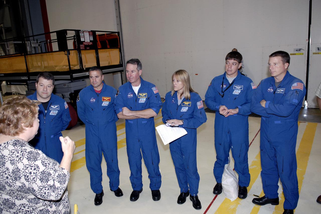 CAPE CANAVERAL, Fla. – In Orbiter Processing Facility-3 at NASA's Kennedy Space Center in Florida, members of the STS-130 crew receive a briefing about the processing of space shuttle Endeavour. From left are Mission Specialist Nicolas Patrick; Commander George Zamka; Mission Specialists Stephen Robinson, Kathryn "Kay" Hire and Robert Behnken; and Pilot Terry Virts Jr.    The crew is at Kennedy for a crew equipment interface test, or CEIT, which provides hands-on training and observation of shuttle and flight hardware.  The STS-130 flight will carry the Tranquility pressurized module with a built-in cupola to the International Space Station aboard Endeavour.  Launch is targeted for Feb. 4, 2010. Photo credit: NASA/Steven Durnin