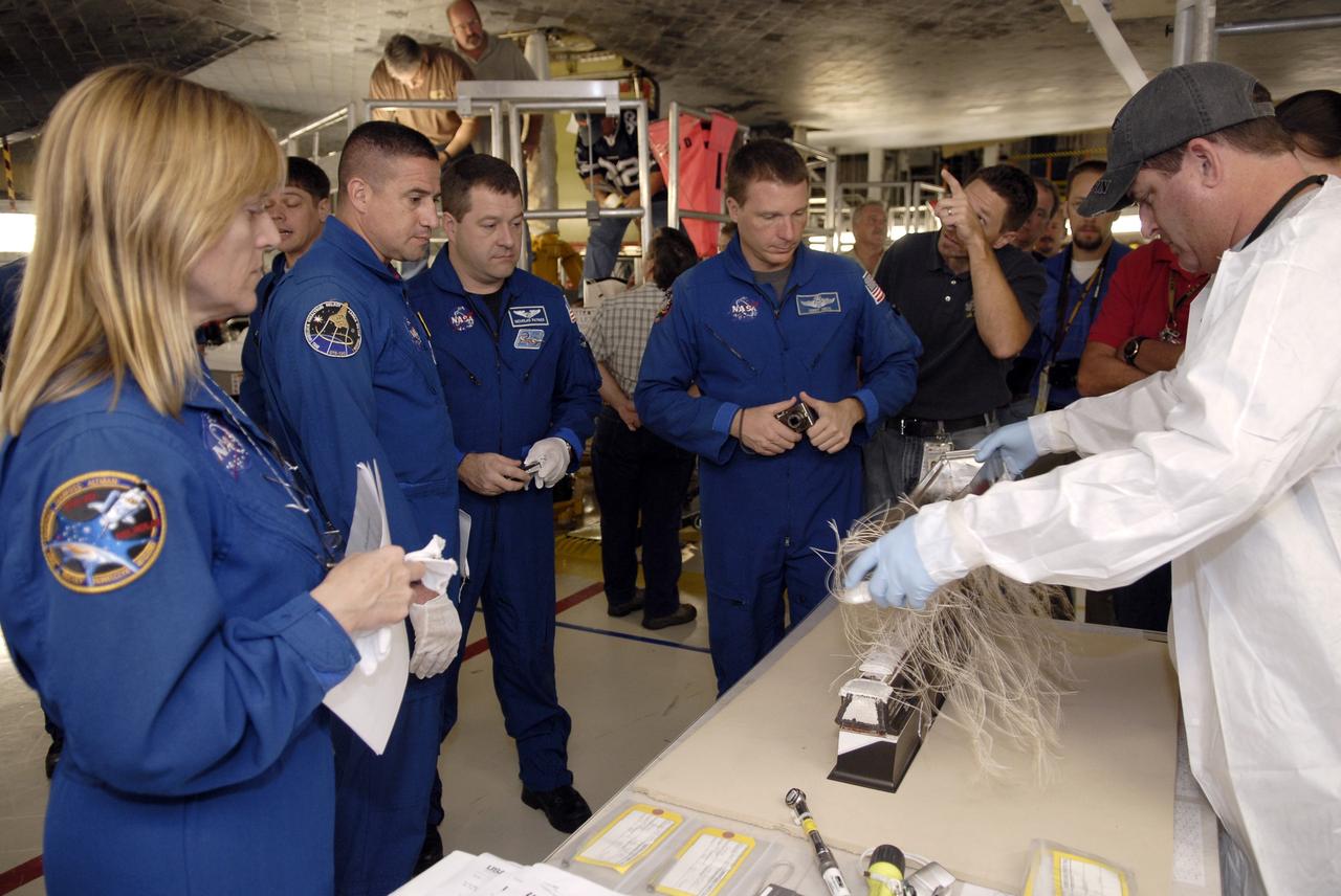 CAPE CANAVERAL, Fla. – In Orbiter Processing Facility-3 at NASA's Kennedy Space Center in Florida, members of the STS-130 crew view a demonstration on the upkeep of space shuttle Endeavour's thermal protection system.  From left are Mission Specialist Kathryn "Kay" Hire, Commander George Zamka, Mission Specialist Nicolas Patrick and Pilot Terry Virts Jr.    The crew is at Kennedy for a crew equipment interface test, or CEIT, which provides hands-on training and observation of shuttle and flight hardware.  The STS-130 flight will carry the Tranquility pressurized module with a built-in cupola to the International Space Station aboard Endeavour.  Launch is targeted for Feb. 4, 2010. Photo credit: NASA/Kim Shiflett