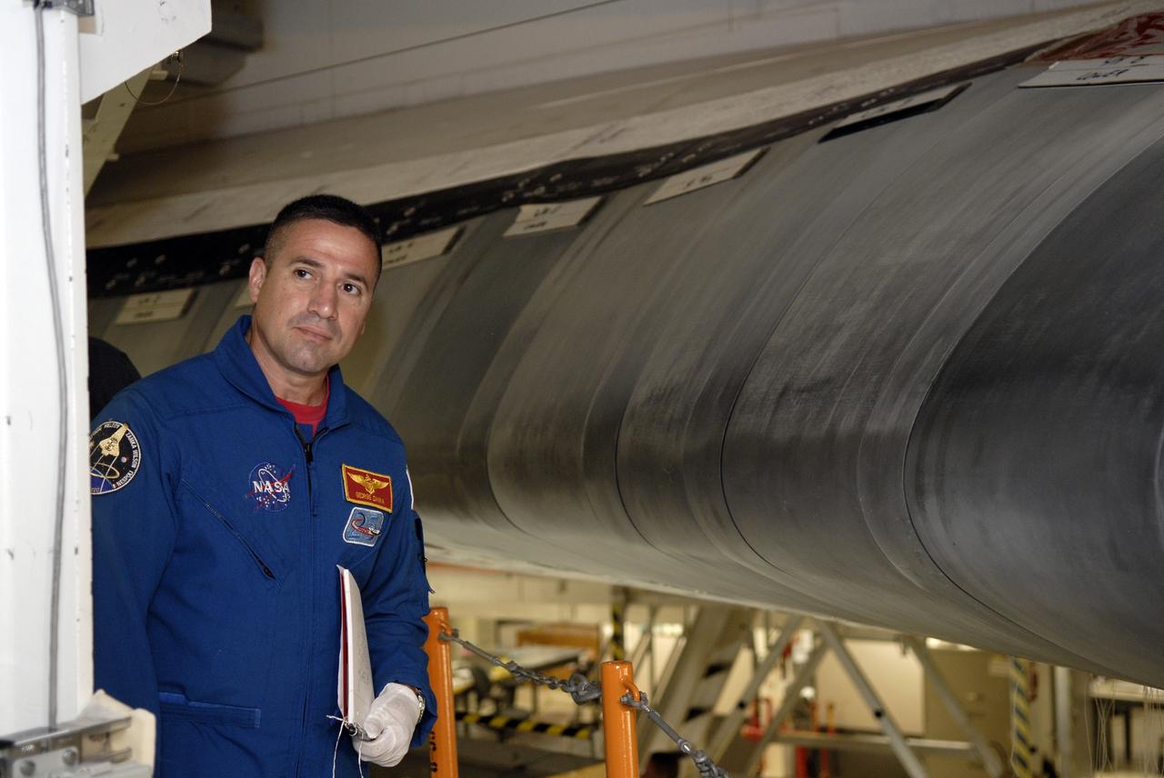 CAPE CANAVERAL, Fla. – In Orbiter Processing Facility-3 at NASA's Kennedy Space Center in Florida, STS-130 Commander George Zamka is briefed on the reinforced carbon carbon panels, part of the thermal protection system, on the leading edge of the wing of space shuttle Endeavour.    The crew is at Kennedy for a crew equipment interface test, or CEIT, which provides hands-on training and observation of shuttle and flight hardware.  The STS-130 flight will carry the Tranquility pressurized module with a built-in cupola to the International Space Station aboard Endeavour.  Launch is targeted for Feb. 4, 2010. Photo credit: NASA/Kim Shiflett