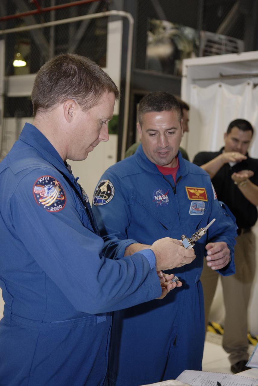 CAPE CANAVERAL, Fla. – In Orbiter Processing Facility-3 at NASA's Kennedy Space Center in Florida, STS-130 Pilot Terry Virts Jr., left, handles a piece of hardware that will fly on space shuttle Endeavour as his commander, George Zamka, looks on.    The crew is at Kennedy for a crew equipment interface test, or CEIT, which provides hands-on training and observation of shuttle and flight hardware.  The STS-130 flight will carry the Tranquility pressurized module with a built-in cupola to the International Space Station aboard Endeavour.  Launch is targeted for Feb. 4, 2010. Photo credit: NASA/Kim Shiflett