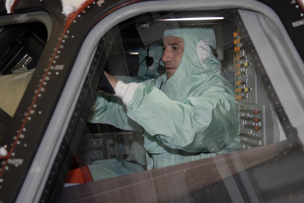 CAPE CANAVERAL, Fla. – In Orbiter Processing Facility-3 at NASA's Kennedy Space Center in Florida, STS-130 Commander George Zamka dressed in clean-room attire, known as a "bunny suit," gets the feel of the cockpit of space shuttle Endeavour.    The crew is at Kennedy for a crew equipment interface test, or CEIT, which provides hands-on training and observation of shuttle and flight hardware.  The STS-130 flight will carry the Tranquility pressurized module with a built-in cupola to the International Space Station aboard Endeavour.  Launch is targeted for Feb. 4, 2010. Photo credit: NASA/Kim Shiflett