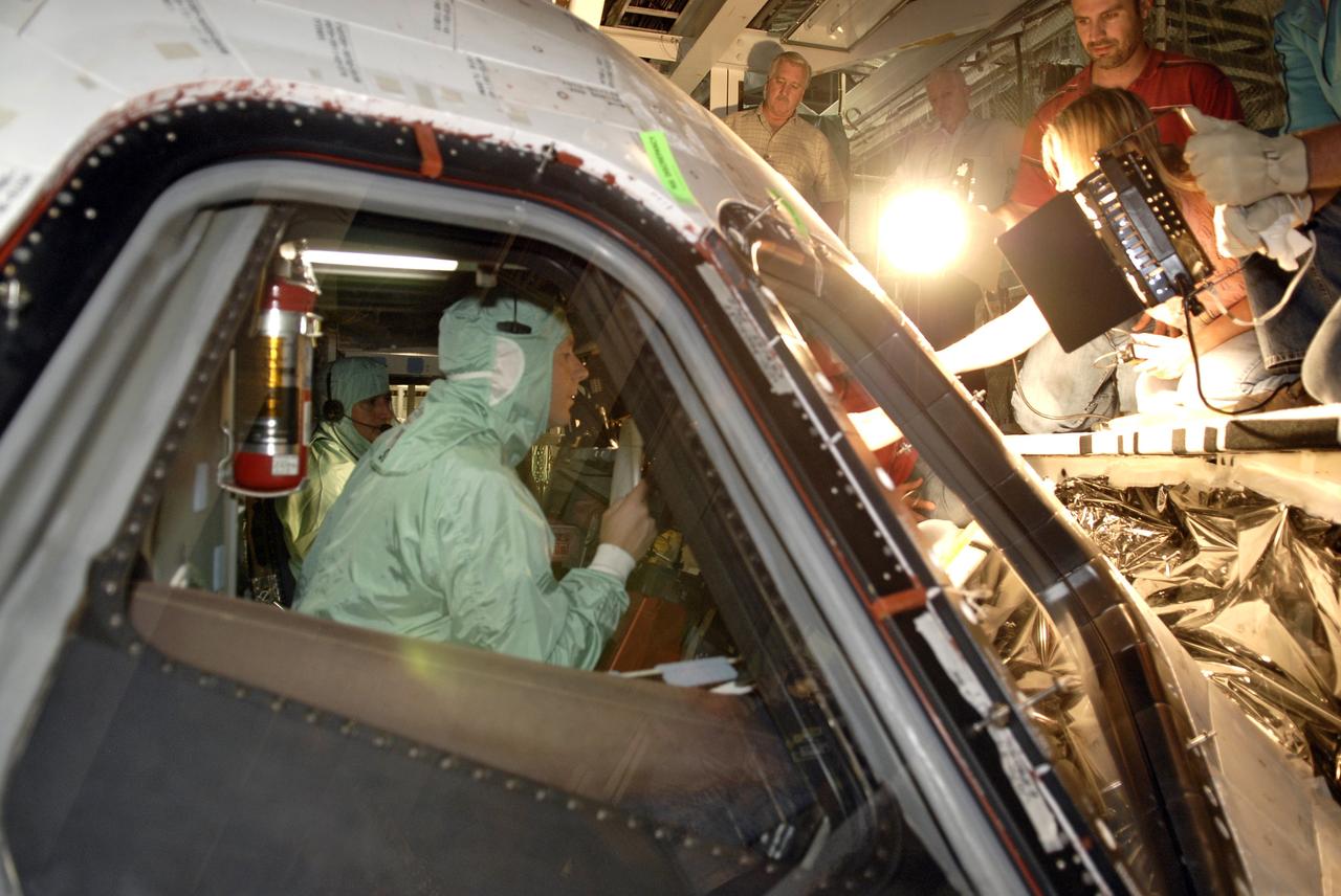 CAPE CANAVERAL, Fla. – In Orbiter Processing Facility-3 at NASA's Kennedy Space Center in Florida, STS-130 Pilot Terry Virts Jr. dressed in clean-room attire, known as a "bunny suit," tries out the cockpit of space shuttle Endeavour.    The crew is at Kennedy for a crew equipment interface test, or CEIT, which provides hands-on training and observation of shuttle and flight hardware.  The STS-130 flight will carry the Tranquility pressurized module with a built-in cupola to the International Space Station aboard Endeavour.  Launch is targeted for Feb. 4, 2010. Photo credit: NASA/Kim Shiflett