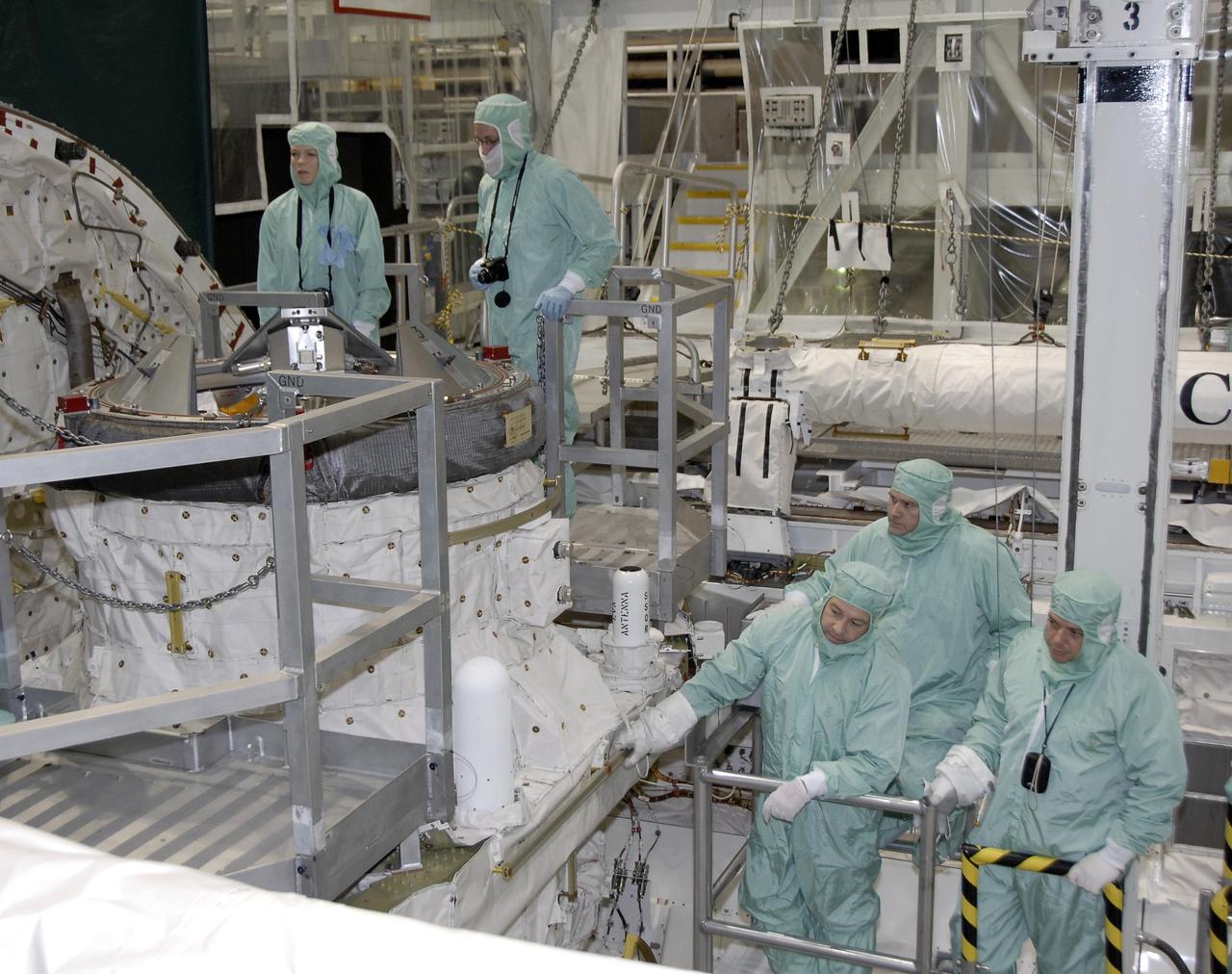 CAPE CANAVERAL, Fla. – In Orbiter Processing Facility-3 at NASA's Kennedy Space Center in Florida, members of the STS-130 crew inspect space shuttle Endeavour's payload bay.  In the right corner, from left are Commander George Zamka, Pilot Terry Virts Jr. and Mission Specialist Robert Behnken.    The crew is at Kennedy for a crew equipment interface test, or CEIT, which provides hands-on training and observation of shuttle and flight hardware.  The STS-130 flight will carry the Tranquility pressurized module with a built-in cupola to the International Space Station aboard Endeavour.  Launch is targeted for Feb. 4, 2010. Photo credit: NASA/Kim Shiflett