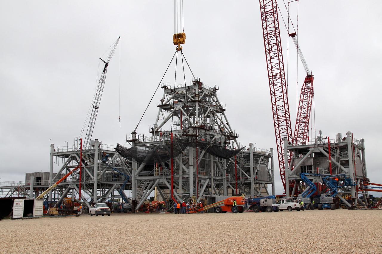 CAPE CANAVERAL, Fla. – At NASA's Kennedy Space Center in Florida, preparations are made to lift the fourth section of the tower onto a new mobile launcher, or ML, being constructed to support the Constellation Program. The tower will be approximately 345 feet tall when completed and have multiple platforms for personnel access. The ML is being built at the mobile launcher park site area north of Kennedy's Vehicle Assembly Building. The launcher will provide a base to launch the Ares I, designed to transport the Orion crew exploration vehicle, its crew and cargo to low Earth orbit. The base is being made lighter than space shuttle mobile launcher platforms so the crawler-transporter can pick up the heavier load of the tower and taller rocket. For information on the Ares I, visit http://www.nasa.gov/ares. Photo credit: NASA/Jack Pfaller