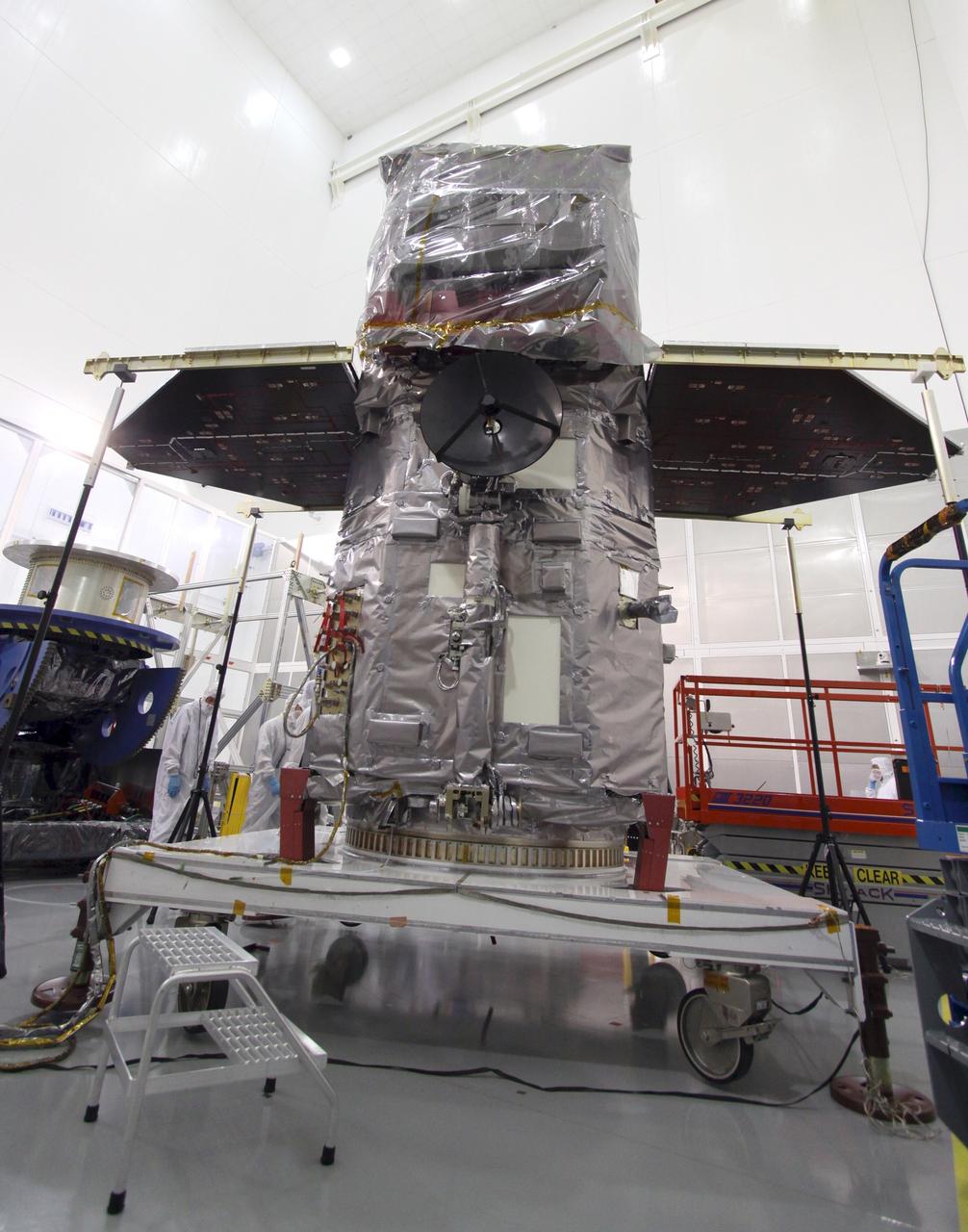 CAPE CANAVERAL, Fla. – At the Astrotech Space Operations facility in Titusville, Fla., the Solar Dynamics Observatory, or SDO, awaits testing of the release mechanism sequence for its solar arrays, now extended, using signal commands.    SDO is the first space weather research network mission in NASA's Living With a Star Program. The spacecraft's long-term measurements will give solar scientists in-depth information about changes in the sun's magnetic field and insight into how they affect Earth. Liftoff on an Atlas V rocket is scheduled for Feb. 3, 2010. Photo credit: NASA/Jack Pfaller