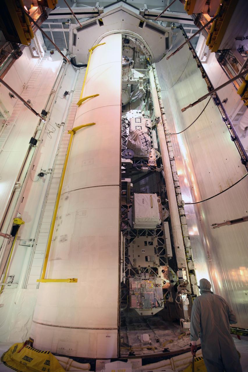 CAPE CANAVERAL, Fla. - At Launch Pad 39A at NASA's Kennedy Space Center in Florida, one of space shuttle Atlantis' payload bay doors is closed around the cargo for Atlantis' STS-129 mission to the International Space Station.  The cargo includes the Express Logistics Carriers 1 and 2.    The STS-129 crew will deliver two spare gyroscopes, two nitrogen tank assemblies, two pump modules, an ammonia tank assembly and a spare latching end effector for the station's robotic arm.  Launch is set for Nov. 16. For information on the STS-129 mission, visit http://www.nasa.gov/mission_pages/shuttle/shuttlemissions/sts129/index.html. Photo credit: NASA/Troy Cryder