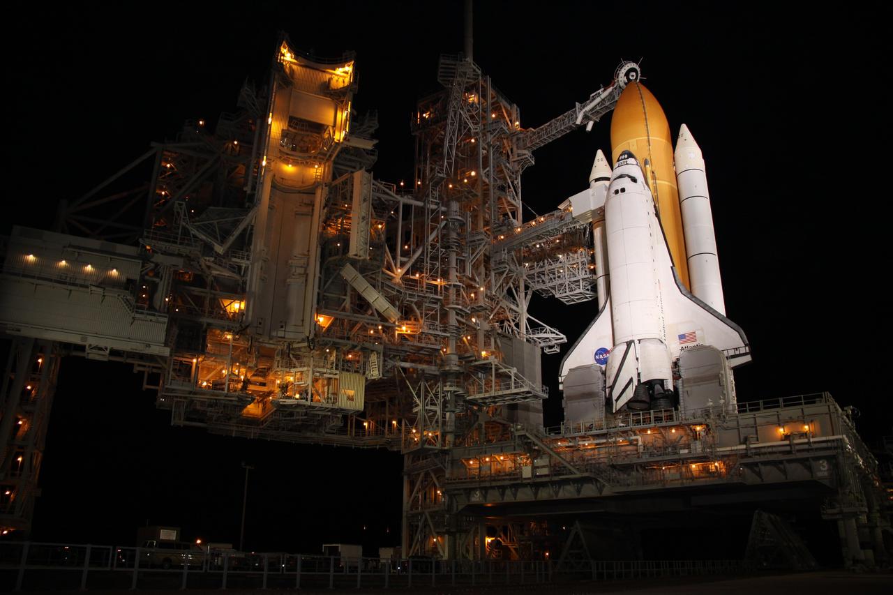 CAPE CANAVERAL, Fla. - After nightfall on Launch Pad 39A at NASA's Kennedy Space Center in Florida, xenon lights reveal space shuttle Atlantis awaiting launch on its mobile launcher platform.  Liftoff of the STS-129 mission is set for 2:28 p.m. EST Nov. 16.  The pad's rotating service structure, at left, which provides weather protection and access for technicians to work on the shuttle, began being retracted at 5:20 p.m. EST and was in the park position by 5:56 p.m.    On STS-129, the crew will deliver to the International Space Station two Express Logistics Carriers, the largest of the shuttle's cargo carriers, containing 15 spare pieces of equipment including two gyroscopes, two nitrogen tank assemblies, two pump modules, an ammonia tank assembly and a spare latching end effector for the station's robotic arm.  Atlantis will return to Earth a station crew member, Nicole Stott, who has spent more than two months aboard the orbiting laboratory.  STS-129 is slated to be the final space shuttle Expedition crew rotation flight.  For information on the STS-129 mission and crew, visit http://www.nasa.gov/mission_pages/shuttle/shuttlemissions/sts129/index.html. Photo credit: NASA/Troy Cryder