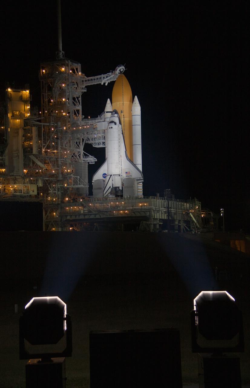 CAPE CANAVERAL, Fla. - After nightfall on Launch Pad 39A at NASA's Kennedy Space Center in Florida, xenon lights reveal space shuttle Atlantis awaiting launch on its mobile launcher platform.  Liftoff of the STS-129 mission is set for 2:28 p.m. EST Nov. 16.  The pad's rotating service structure, at left, which provides weather protection and access for technicians to work on the shuttle, began being retracted at 5:20 p.m. EST and was in the park position by 5:56 p.m.    On STS-129, the crew will deliver to the International Space Station two Express Logistics Carriers, the largest of the shuttle's cargo carriers, containing 15 spare pieces of equipment including two gyroscopes, two nitrogen tank assemblies, two pump modules, an ammonia tank assembly and a spare latching end effector for the station's robotic arm.  Atlantis will return to Earth a station crew member, Nicole Stott, who has spent more than two months aboard the orbiting laboratory.  STS-129 is slated to be the final space shuttle Expedition crew rotation flight.  For information on the STS-129 mission and crew, visit http://www.nasa.gov/mission_pages/shuttle/shuttlemissions/sts129/index.html. Photo credit: NASA/Troy Cryder