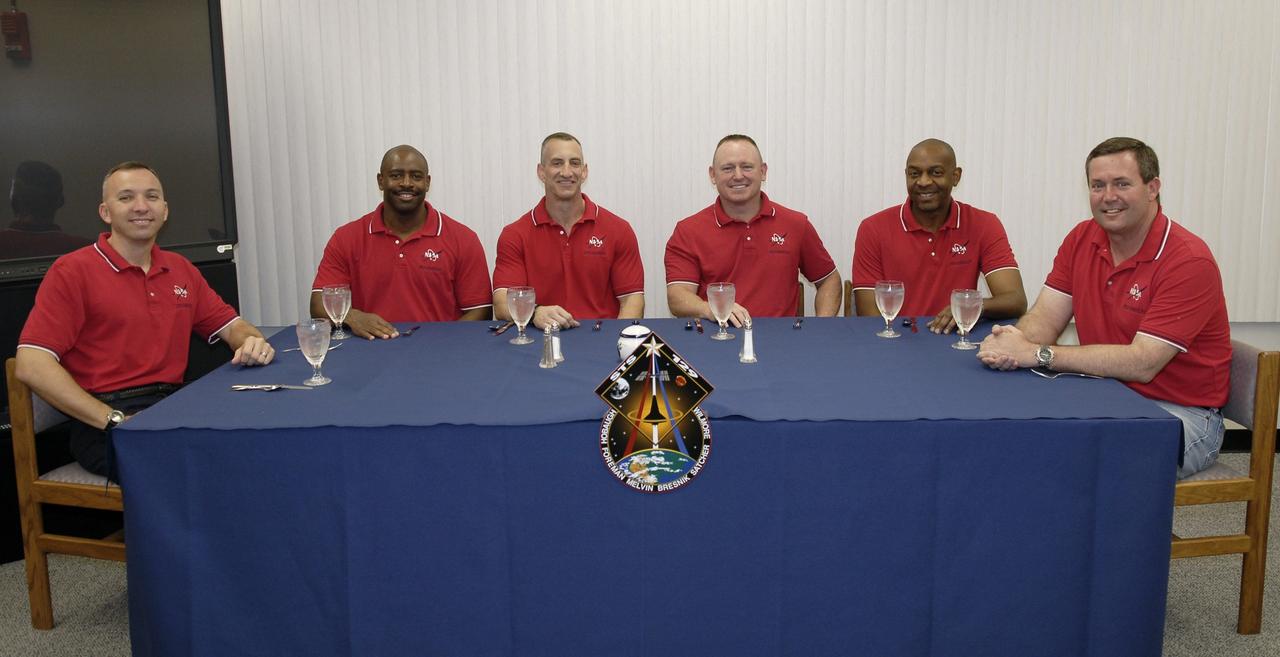 CAPE CANAVERAL, Fla. - The members of the STS-129 crew enjoy breakfast together on launch day in the Operations and Checkout Building at NASA's Kennedy Space Center in Florida.  From left are Mission Specialists Randy Bresnik and Leland Melvin; Commander Charles O. Hobaugh; Pilot Barry E. Wilmore; and Mission Specialists Robert L. Satcher Jr. and Mike Foreman.    Liftoff is set for 2:28 p.m. EST Nov. 16.  On STS-129, the crew will deliver two Express Logistics Carriers to the International Space Station, the largest of the shuttle's cargo carriers, containing 15 spare pieces of equipment including two gyroscopes, two nitrogen tank assemblies, two pump modules, an ammonia tank assembly and a spare latching end effector for the station's robotic arm.  Atlantis will return to Earth a station crew member, Nicole Stott, who has spent more than two months aboard the orbiting laboratory.  STS-129 is slated to be the final space shuttle Expedition crew rotation flight.  For information on the STS-129 mission and crew, visit http://www.nasa.gov/mission_pages/shuttle/shuttlemissions/sts129/index.html. Photo credit: NASA/Kim Shiflett