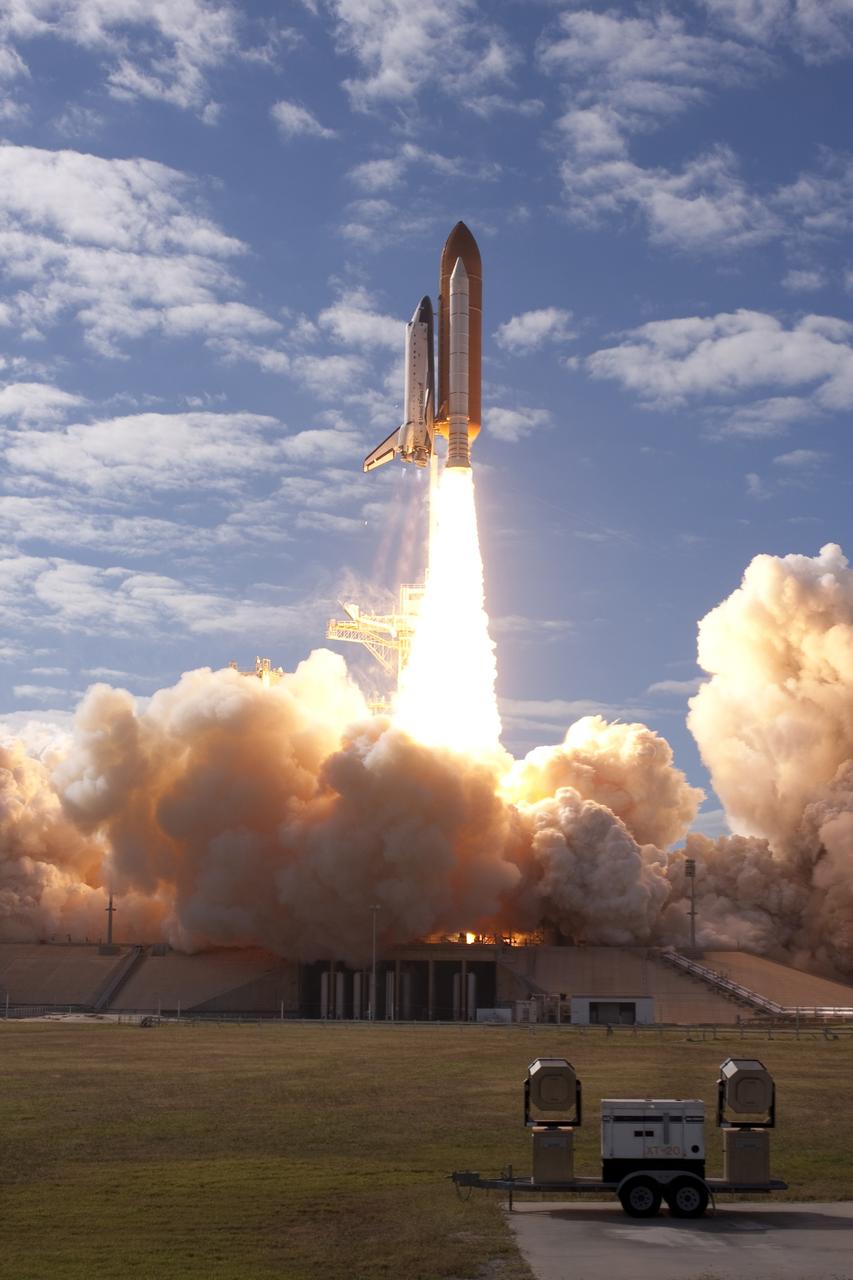 CAPE CANAVERAL, Fla. - An exhaust cloud builds on Launch Pad 39A as the solid rocket motors ignite, launching space shuttle Atlantis on a perfect Florida afternoon at NASA's Kennedy Space Center.    Liftoff on its STS-129 mission came at 2:28 p.m. EST Nov. 16.  Aboard are crew members Commander Charles O. Hobaugh; Pilot Barry E. Wilmore; and Mission Specialists Leland Melvin, Randy Bresnik, Mike Foreman and Robert L. Satcher Jr.  On STS-129, the crew will deliver two ExPRESS Logistics Carriers to the International Space Station, the largest of the shuttle's cargo carriers, containing 15 spare pieces of equipment including two gyroscopes, two nitrogen tank assemblies, two pump modules, an ammonia tank assembly and a spare latching end effector for the station's robotic arm.  Atlantis will return to Earth a station crew member, Nicole Stott, who has spent more than two months aboard the orbiting laboratory.  STS-129 is slated to be the final space shuttle Expedition crew rotation flight. For information on the STS-129 mission and crew, visit http://www.nasa.gov/mission_pages/shuttle/shuttlemissions/sts129/index.html.    Photo courtesy of Scott Andrews