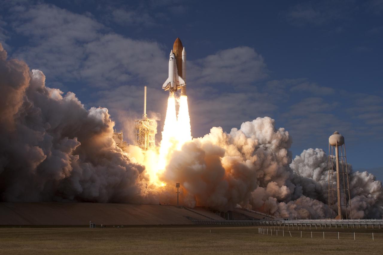 CAPE CANAVERAL, Fla. - Like a phoenix rising from the flames, space shuttle Atlantis emerges from the exhaust cloud building on Launch Pad 39A at NASA's Kennedy Space Center in Florida.    Liftoff on its STS-129 mission came at 2:28 p.m. EST Nov. 16.  Aboard are crew members Commander Charles O. Hobaugh; Pilot Barry E. Wilmore; and Mission Specialists Leland Melvin, Randy Bresnik, Mike Foreman and Robert L. Satcher Jr.  On STS-129, the crew will deliver two ExPRESS Logistics Carriers to the International Space Station, the largest of the shuttle's cargo carriers, containing 15 spare pieces of equipment including two gyroscopes, two nitrogen tank assemblies, two pump modules, an ammonia tank assembly and a spare latching end effector for the station's robotic arm.  Atlantis will return to Earth a station crew member, Nicole Stott, who has spent more than two months aboard the orbiting laboratory.  STS-129 is slated to be the final space shuttle Expedition crew rotation flight. For information on the STS-129 mission and crew, visit http://www.nasa.gov/mission_pages/shuttle/shuttlemissions/sts129/index.html.    Photo courtesy of Scott Andrews