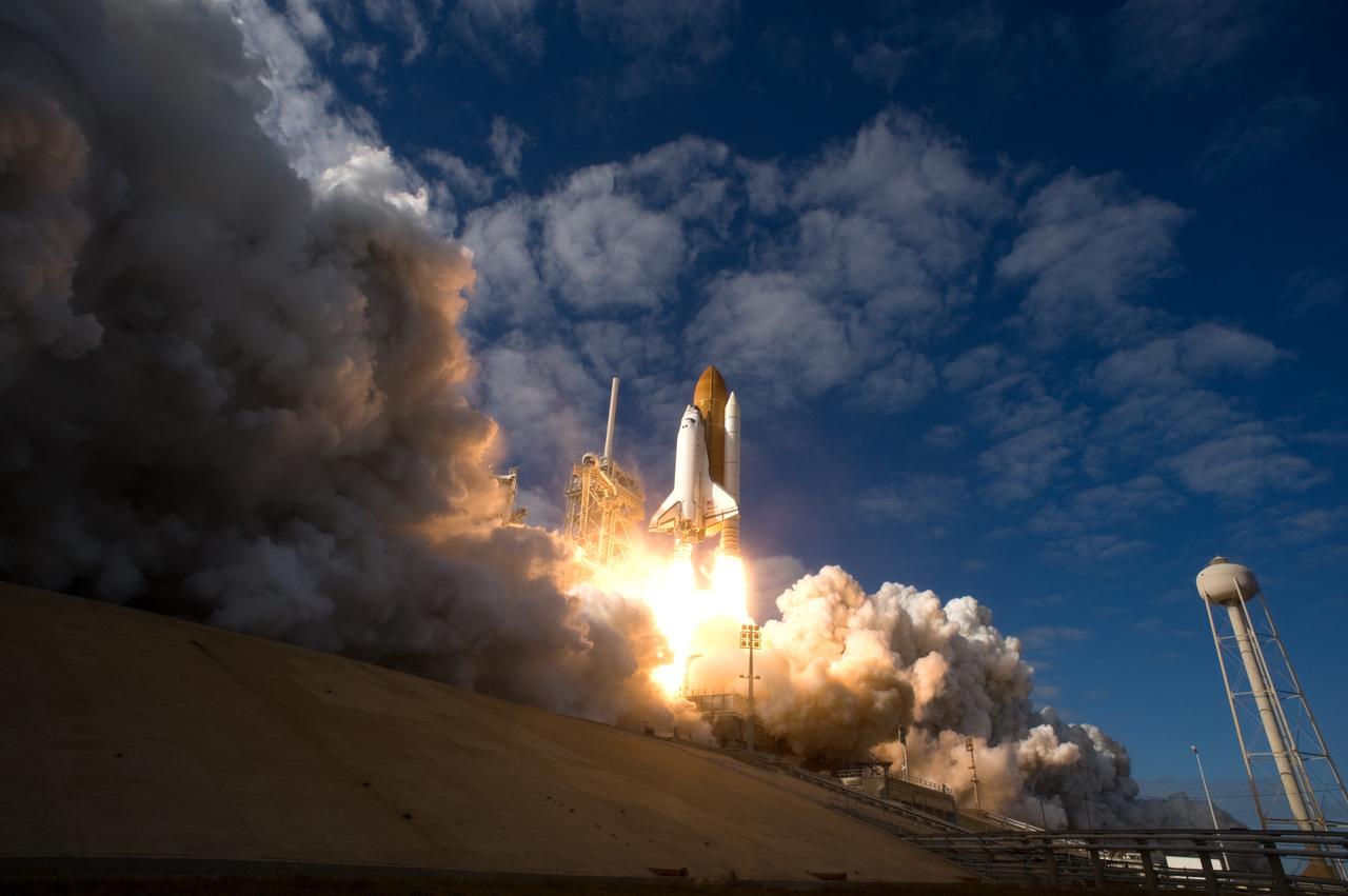 CAPE CANAVERAL, Fla. - Like a phoenix rising from the flames, space shuttle Atlantis emerges from the exhaust cloud building on Launch Pad 39A at NASA's Kennedy Space Center in Florida.    Liftoff on its STS-129 mission came at 2:28 p.m. EST Nov. 16.  Aboard are crew members Commander Charles O. Hobaugh; Pilot Barry E. Wilmore; and Mission Specialists Leland Melvin, Randy Bresnik, Mike Foreman and Robert L. Satcher Jr.  On STS-129, the crew will deliver two ExPRESS Logistics Carriers to the International Space Station, the largest of the shuttle's cargo carriers, containing 15 spare pieces of equipment including two gyroscopes, two nitrogen tank assemblies, two pump modules, an ammonia tank assembly and a spare latching end effector for the station's robotic arm.  Atlantis will return to Earth a station crew member, Nicole Stott, who has spent more than two months aboard the orbiting laboratory.  STS-129 is slated to be the final space shuttle Expedition crew rotation flight. For information on the STS-129 mission and crew, visit http://www.nasa.gov/mission_pages/shuttle/shuttlemissions/sts129/index.html.    Photo credit: NASA/Sandra Joseph and Kevin O'Connell
