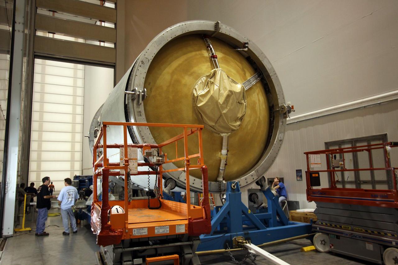 CAPE CANAVERAL, Fla. – Workers prepare to hoist the second stage of a Delta IV rocket into a test cell for checkout in the hangar of the Delta Operations Center at Cape Canaveral Air Force Station in Florida. The United Launch Alliance Delta IV rocket is the vehicle slated to launch GOES-P, the latest Geostationary Operational Environmental Satellite developed by NASA for the National Oceanic and Atmospheric Administration, or NOAA. A meteorological satellite, GOES-P is designed to watch for storm development and observed current weather conditions on Earth. Launch of GOES-P is scheduled for no earlier than Feb. 25, 2010, from Launch Complex 37. For information on GOES-P, visit http://goespoes.gsfc.nasa.gov/goes/spacecraft/n_p_spacecraft.html. Photo credit: NASA/Troy Cryder