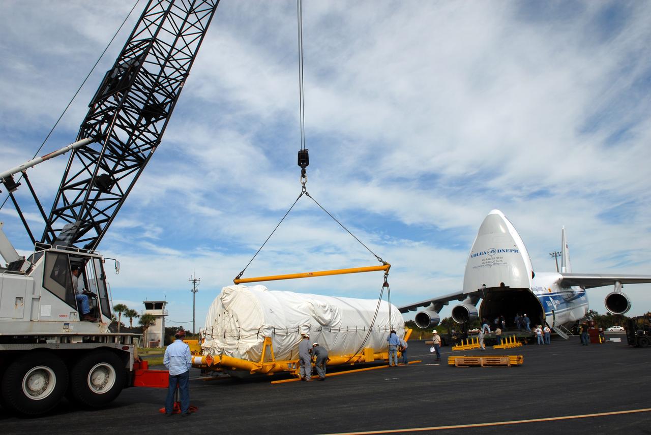 CAPE CANAVERAL, Fla. – At the Skid Strip on Cape Canaveral Air Force Station in Florida, a crane prepares to lift the Centaur second stage for the Atlas V rocket slated to launch NASA's Solar Dynamics Observatory, or SDO, onto a transporter.  The stage was delivered aboard the Volga-Dnepr Antonov AN-124-100, a Ukranian/Russian aircraft, at right.    SDO is the first space weather research network mission in NASA's Living With a Star Program. The spacecraft's long-term measurements will give solar scientists in-depth information about changes in the sun's magnetic field and insight into how they affect Earth. Liftoff on the United Launch Alliance Atlas V is scheduled for Feb. 3, 2010. For information on SDO, visit http://www.nasa.gov/sdo.  Photo credit: NASA/Jim Grossmann