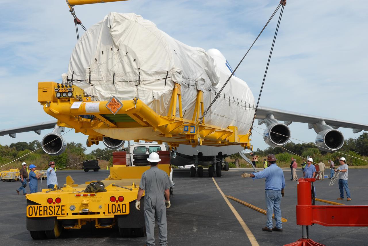 CAPE CANAVERAL, Fla. – At the Skid Strip on Cape Canaveral Air Force Station in Florida, a crane lifts the Centaur second stage for the Atlas V rocket slated to launch NASA's Solar Dynamics Observatory, or SDO, onto a transporter.  The stage was delivered aboard the Volga-Dnepr Antonov AN-124-100, a Ukranian/Russian aircraft, behind it.    SDO is the first space weather research network mission in NASA's Living With a Star Program. The spacecraft's long-term measurements will give solar scientists in-depth information about changes in the sun's magnetic field and insight into how they affect Earth. Liftoff on the United Launch Alliance Atlas V is scheduled for Feb. 3, 2010. For information on SDO, visit http://www.nasa.gov/sdo.  Photo credit: NASA/Jim Grossmann