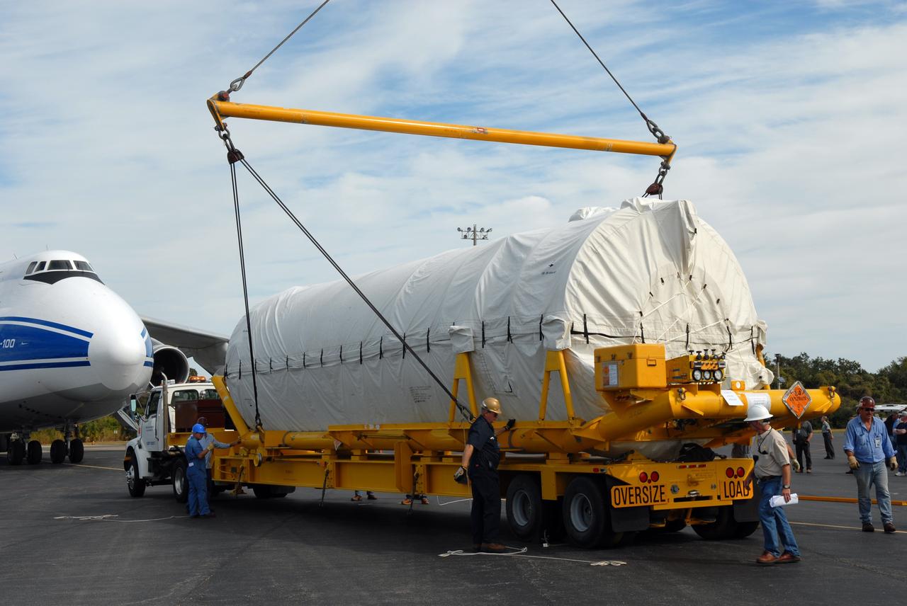 CAPE CANAVERAL, Fla. – At the Skid Strip on Cape Canaveral Air Force Station in Florida, a crane lowers the Centaur second stage for the Atlas V rocket slated to launch NASA's Solar Dynamics Observatory, or SDO, onto a transporter.  The stage was delivered aboard the Volga-Dnepr Antonov AN-124-100, a Ukranian/Russian aircraft, at left.    SDO is the first space weather research network mission in NASA's Living With a Star Program. The spacecraft's long-term measurements will give solar scientists in-depth information about changes in the sun's magnetic field and insight into how they affect Earth. Liftoff on the United Launch Alliance Atlas V is scheduled for Feb. 3, 2010. For information on SDO, visit http://www.nasa.gov/sdo.  Photo credit: NASA/Jim Grossmann
