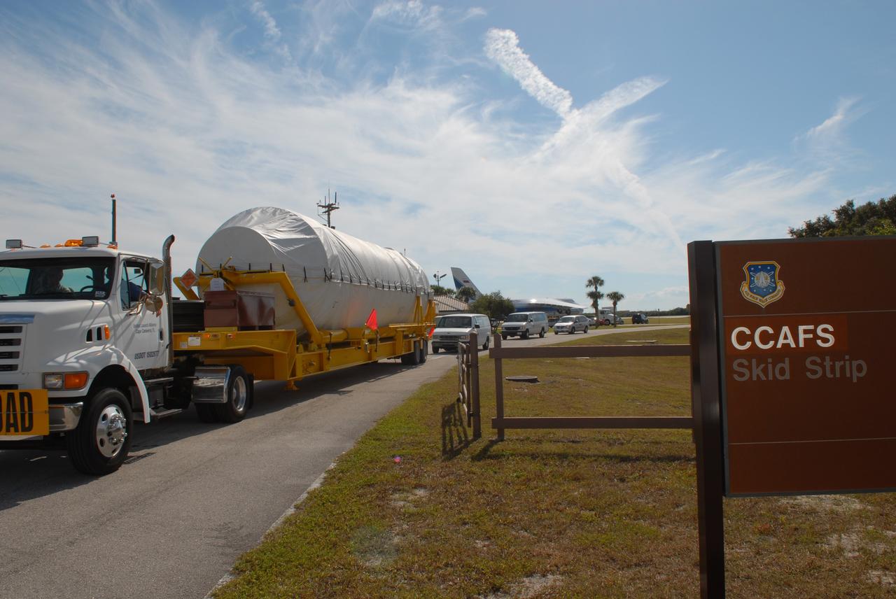 CAPE CANAVERAL, Fla. – The Centaur second stage for the Atlas V rocket slated to launch NASA's Solar Dynamics Observatory, or SDO, is transported from the Skid Strip on Cape Canaveral Air Force Station in Florida to the Atlas Spaceflight Operations Center.  The stage was delivered aboard the Volga-Dnepr Antonov AN-124-100, a Ukranian/Russian aircraft, in the background.    SDO is the first space weather research network mission in NASA's Living With a Star Program. The spacecraft's long-term measurements will give solar scientists in-depth information about changes in the sun's magnetic field and insight into how they affect Earth. Liftoff on the United Launch Alliance Atlas V is scheduled for Feb. 3, 2010. For information on SDO, visit http://www.nasa.gov/sdo.  Photo credit: NASA/Jim Grossmann