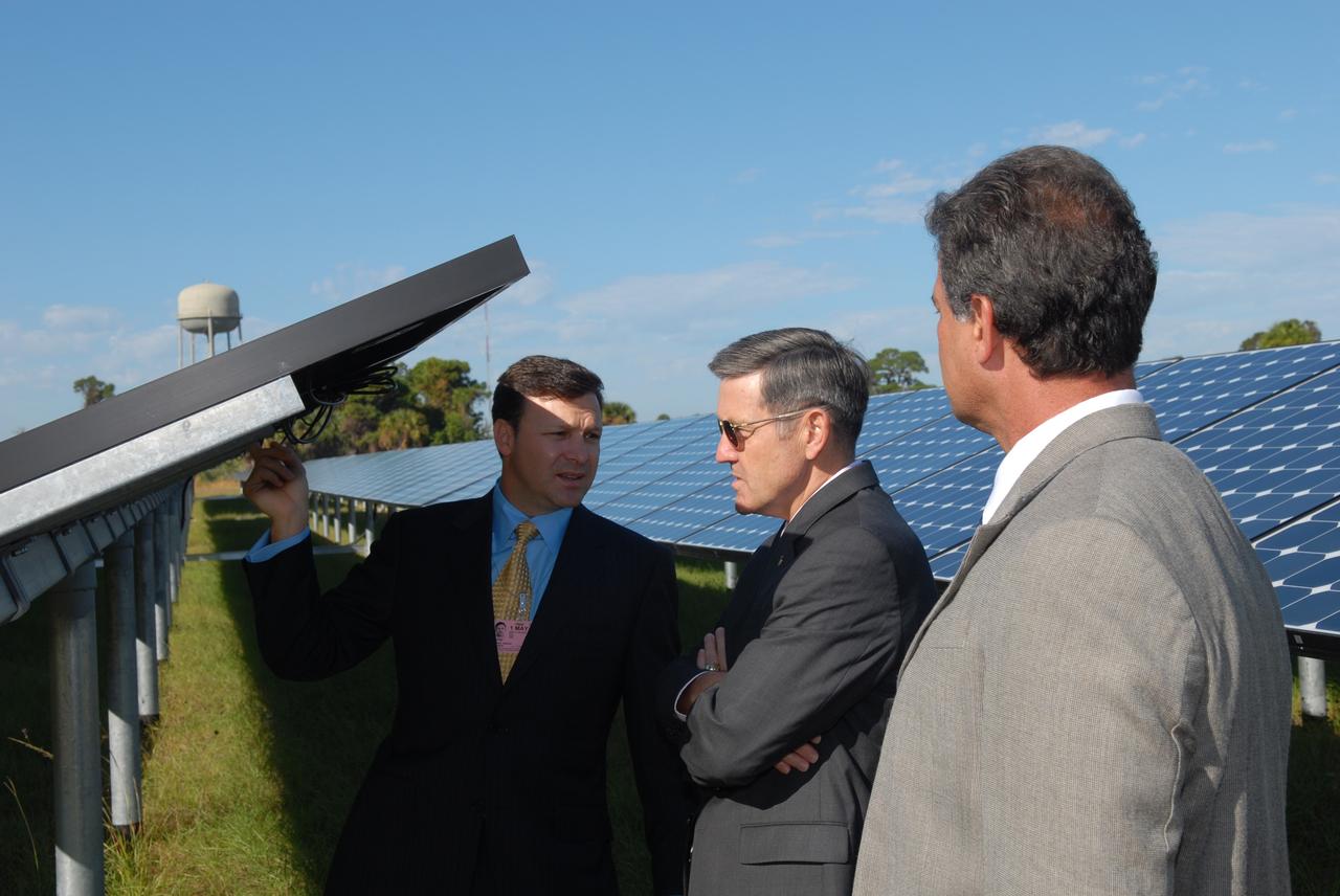 CAPE CANAVERAL, Fla. – Florida Power & Light Company Vice President and Chief Development Officer Eric Silagy, left, and NASA Kennedy Space Center Director Bob Cabana, center, examine one of the solar panels at the unveiling of NASA's first large-scale solar power generation facility at Kennedy in Florida. Representatives from NASA, Florida Power & Light Company, or FPL, and SunPower Corporation formally commissioned the one-megawatt facility and announced plans to pursue a new research, development and demonstration project at Kennedy to advance America's use of renewable energy. The facility is the first element of a major renewable energy project currently under construction at Kennedy. The completed system features a fixed-tilt, ground-mounted solar power system designed and built by SunPower, along with SunPower solar panels. A 10-megawatt solar farm, which SunPower is building on nearby Kennedy property, will supply power to FPL's customers when it is completed in April 2010. Photo credit: NASA/Jim Grossmann