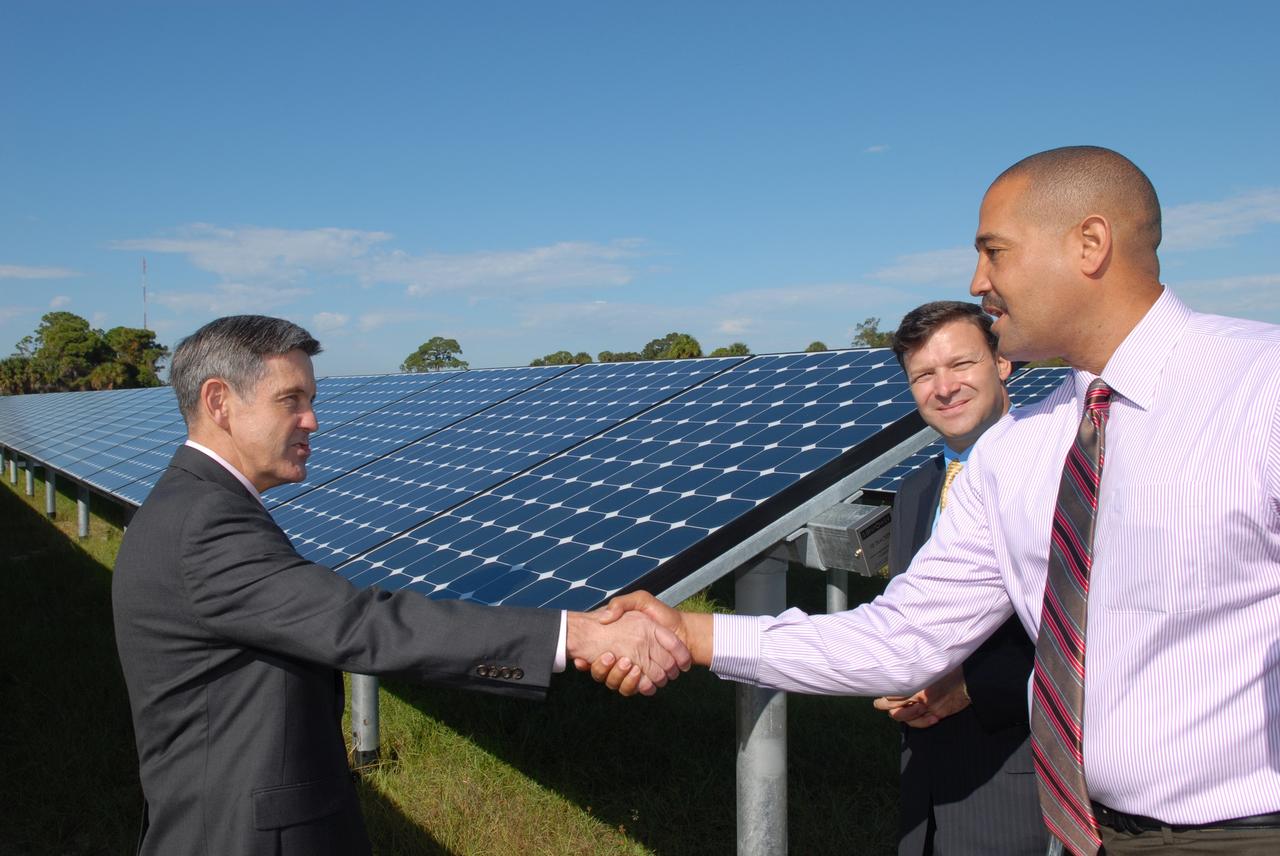CAPE CANAVERAL, Fla. – At NASA's Kennedy Space Center in Florida, Kennedy Director Bob Cabana, left, congratulates Roderick Roche, senior manager, Project Management Office of North America, SunPower Corporation, for his part in the construction of NASA's first large-scale solar power generation facility as Eric Silagy, Florida Power & Light Company vice president and chief development officer, looks on. Representatives from NASA, Florida Power & Light Company, or FPL, and SunPower Corporation formally commissioned the one-megawatt facility and announced plans to pursue a new research, development and demonstration project at Kennedy to advance America's use of renewable energy. The facility is the first element of a major renewable energy project currently under construction at Kennedy. The completed system features a fixed-tilt, ground-mounted solar power system designed and built by SunPower, along with SunPower solar panels. A 10-megawatt solar farm, which SunPower is building on nearby Kennedy property, will supply power to FPL's customers when it is completed in April 2010. Photo credit: NASA/Jim Grossmann