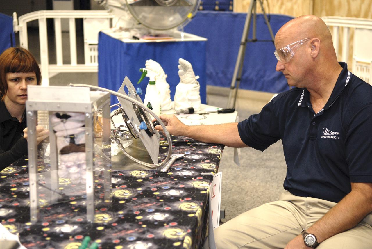 CAPE CANAVERAL, Fla. – A representative of ILC Dover monitors how much internal pressure a newly designed glove can withstand during a burst test at the 2009 Astronaut Glove Challenge, part of NASA’s Centennial Challenges Program, at the Astronaut Hall of Fame near NASA’s Kennedy Space Center in Florida.    The nationwide competition focused on developing improved pressure suit gloves for astronauts to use while working in space.  During the challenge, inventors tested the gloves to measure dexterity and strength during operation in a glove box which simulates the vacuum of space.  Centennial Challenges is NASA’s program of technology prizes for the citizen-inventor.  The winning prize for the Glove Challenge is $250,000 provided by the Centennial Challenges Program.  Photo credit: NASA/Kim Shiflett