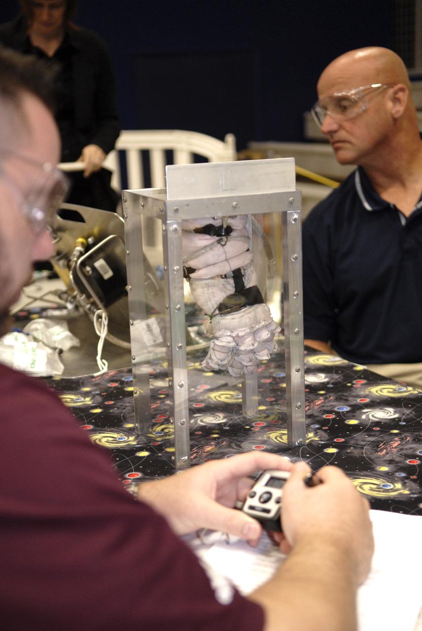 CAPE CANAVERAL, Fla. – Representatives of ILC Dover monitor how much internal pressure a newly designed glove can withstand during a burst test at the 2009 Astronaut Glove Challenge, part of NASA’s Centennial Challenges Program, at the Astronaut Hall of Fame near NASA’s Kennedy Space Center in Florida.    The nationwide competition focused on developing improved pressure suit gloves for astronauts to use while working in space.  During the challenge, inventors tested the gloves to measure dexterity and strength during operation in a glove box which simulates the vacuum of space.  Centennial Challenges is NASA’s program of technology prizes for the citizen-inventor.  The winning prize for the Glove Challenge is $250,000 provided by the Centennial Challenges Program.  Photo credit: NASA/Kim Shiflett
