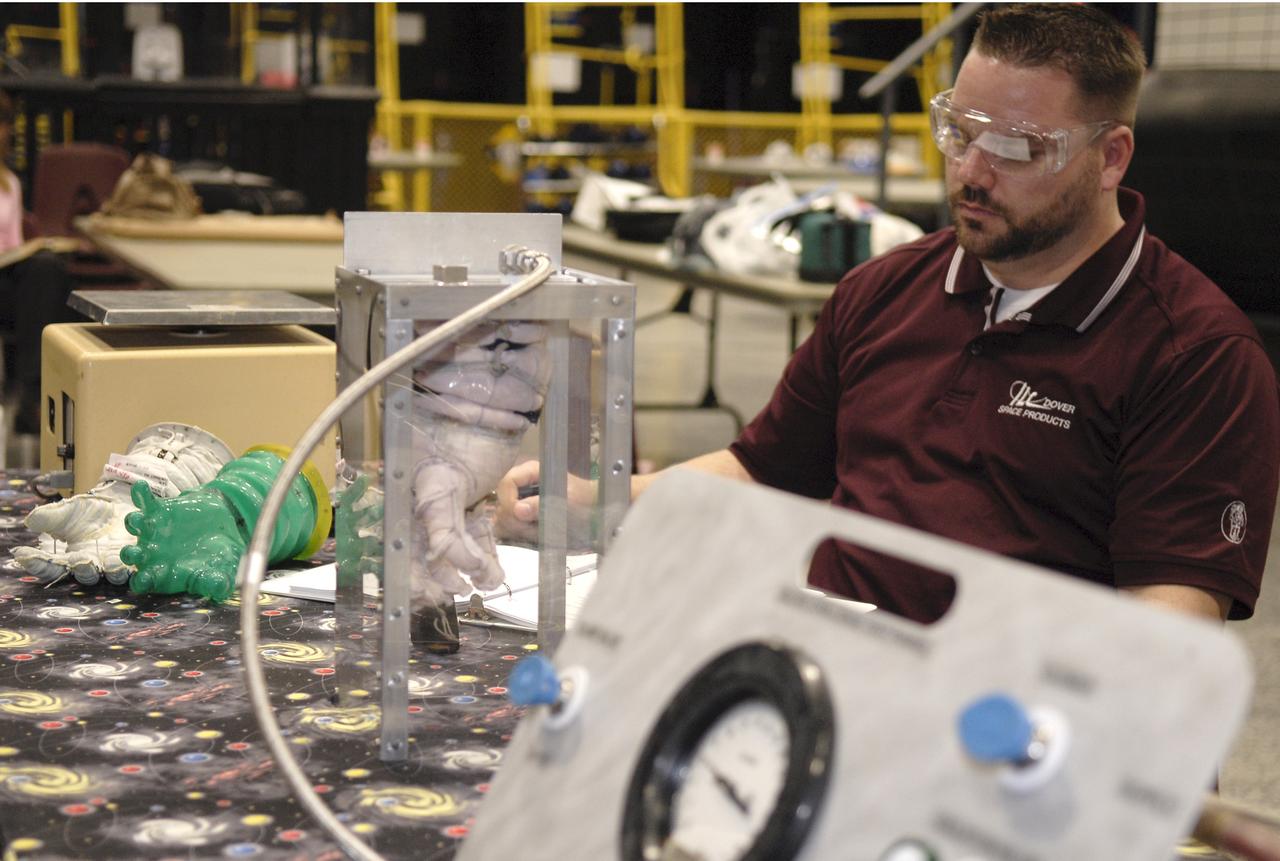 CAPE CANAVERAL, Fla. – A representative of ILC Dover monitors how much internal pressure a newly designed glove can withstand during a burst test at the 2009 Astronaut Glove Challenge, part of NASA’s Centennial Challenges Program, at the Astronaut Hall of Fame near NASA’s Kennedy Space Center in Florida.    The nationwide competition focused on developing improved pressure suit gloves for astronauts to use while working in space.  During the challenge, inventors tested the gloves to measure dexterity and strength during operation in a glove box which simulates the vacuum of space.  Centennial Challenges is NASA’s program of technology prizes for the citizen-inventor.  The winning prize for the Glove Challenge is $250,000 provided by the Centennial Challenges Program.  Photo credit: NASA/Kim Shiflett