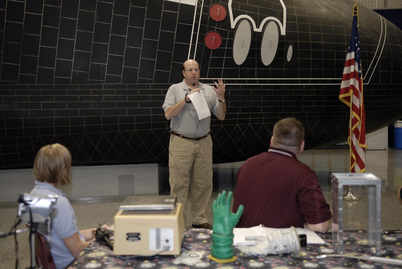 CAPE CANAVERAL, Fla. – Alan Hayes, at microphone, chairman of Volanz Aerospace Inc., addresses the participants in the 2009 Astronaut Glove Challenge, part of NASA’s Centennial Challenges Program, at the Astronaut Hall of Fame near NASA’s Kennedy Space Center in Florida.  Volanz Aerospace Inc., of Owings, Md., administers the competition at no cost to NASA.    The nationwide competition focused on developing improved pressure suit gloves for astronauts to use while working in space.  During the challenge, inventors tested the gloves to measure dexterity and strength during operation in a glove box which simulates the vacuum of space.  Centennial Challenges is NASA’s program of technology prizes for the citizen-inventor.  The winning prize for the Glove Challenge is $250,000 provided by the Centennial Challenges Program.  Photo credit: NASA/Kim Shiflett