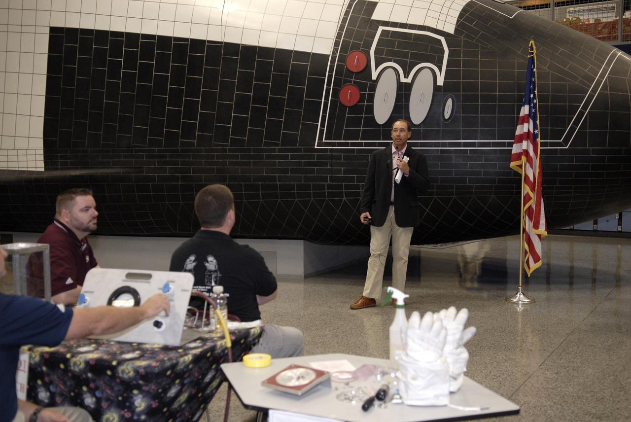 CAPE CANAVERAL, Fla. – Andy Petro, at microphone, manager of NASA Centennial Challenges, addresses the participants in the 2009 Astronaut Glove Challenge, part of NASA’s Centennial Challenges Program, at the Astronaut Hall of Fame near NASA’s Kennedy Space Center in Florida.    The nationwide competition focused on developing improved pressure suit gloves for astronauts to use while working in space.  During the challenge, inventors tested the gloves to measure dexterity and strength during operation in a glove box which simulates the vacuum of space.  Centennial Challenges is NASA’s program of technology prizes for the citizen-inventor.  The winning prize for the Glove Challenge is $250,000 provided by the Centennial Challenges Program.  Photo credit: NASA/Kim Shiflett