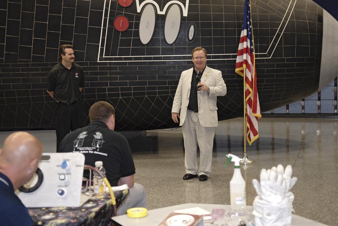 CAPE CANAVERAL, Fla. – Doug Comstock, at microphone, director of the NASA Innovative Partnerships Program, addresses the participants in the 2009 Astronaut Glove Challenge, part of NASA’s Centennial Challenges Program, at the Astronaut Hall of Fame near NASA’s Kennedy Space Center in Florida.    The nationwide competition focused on developing improved pressure suit gloves for astronauts to use while working in space.  During the challenge, inventors tested the gloves to measure dexterity and strength during operation in a glove box which simulates the vacuum of space.  Centennial Challenges is NASA’s program of technology prizes for the citizen-inventor.  The winning prize for the Glove Challenge is $250,000 provided by the Centennial Challenges Program.  Photo credit: NASA/Kim Shiflett