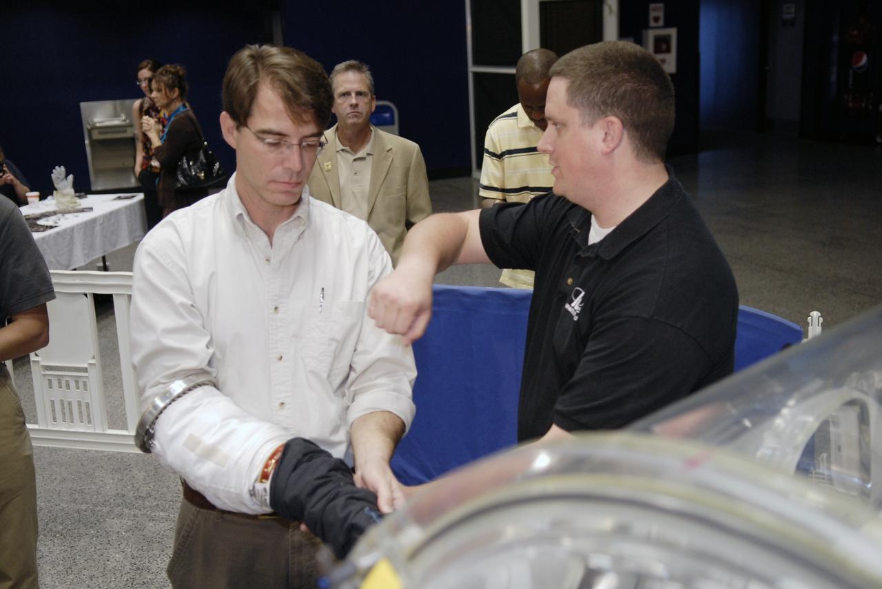 CAPE CANAVERAL, Fla. – Independent inventor Peter Homer, founder of Flagsuit LLC, submits a glove which he designed to a dexterity and flexibility test during the 2009 Astronaut Glove Challenge, part of NASA’s Centennial Challenges Program, at the Astronaut Hall of Fame near NASA’s Kennedy Space Center in Florida.  Homer was the winner of the competition held in 2007.    The nationwide competition focused on developing improved pressure suit gloves for astronauts to use while working in space.  During the challenge, inventors tested the gloves to measure dexterity and strength during operation in a glove box which simulates the vacuum of space.  Centennial Challenges is NASA’s program of technology prizes for the citizen-inventor.  The winning prize for the Glove Challenge is $250,000 provided by the Centennial Challenges Program.  Photo credit: NASA/Kim Shiflett