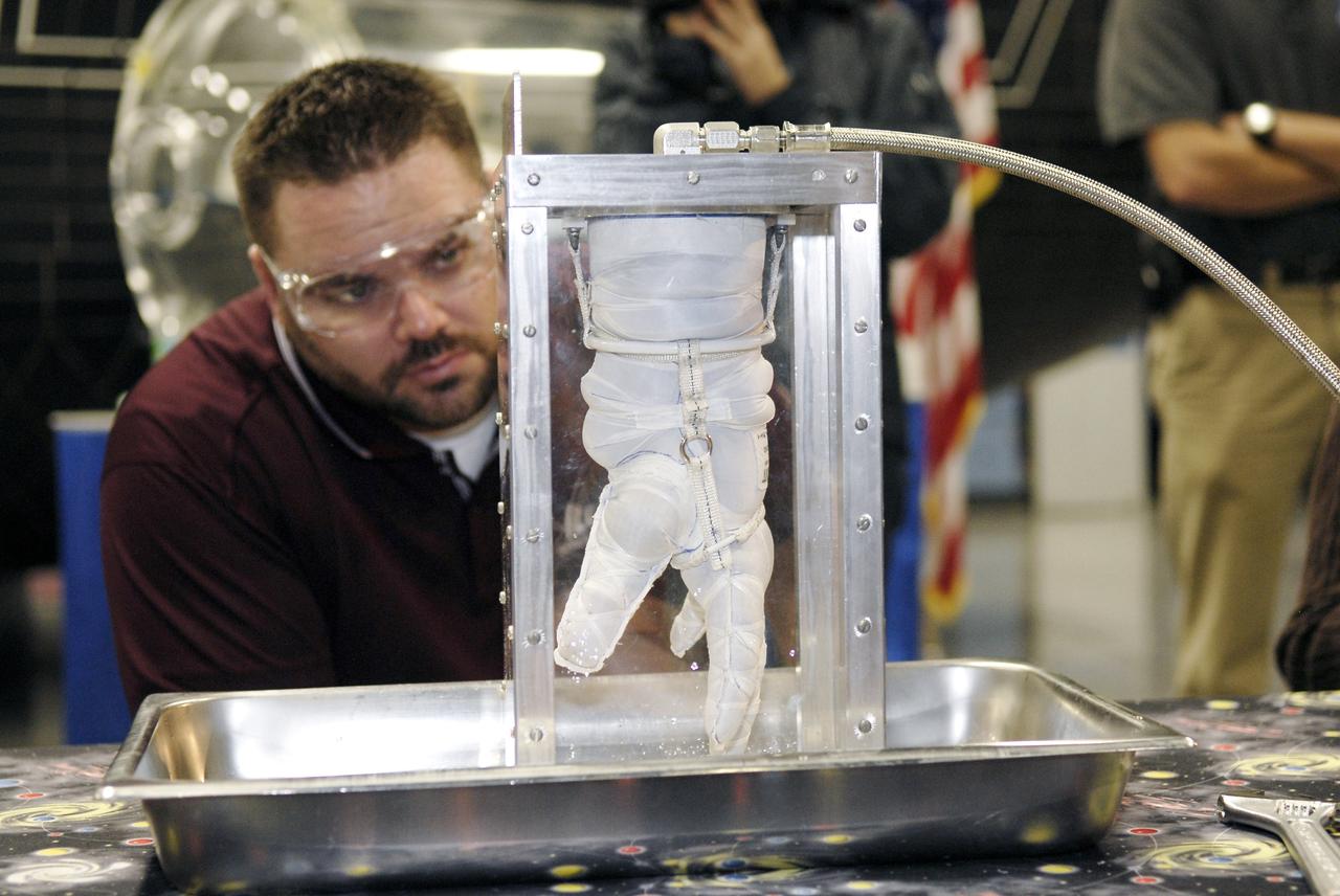 CAPE CANAVERAL, Fla. – A representative of ILC Dover monitors how much internal pressure a newly designed glove can withstand during a burst test at the 2009 Astronaut Glove Challenge, part of NASA’s Centennial Challenges Program, at the Astronaut Hall of Fame near NASA’s Kennedy Space Center in Florida.    The nationwide competition focused on developing improved pressure suit gloves for astronauts to use while working in space.  During the challenge, the gloves were submitted to burst tests, joint force tests and tests to measure their dexterity and strength during operation in a glove box which simulates the vacuum of space.  Centennial Challenges is NASA’s program of technology prizes for the citizen-inventor. The winning prize for the Glove Challenge is $250,000 provided by the Centennial Challenges Program.  Photo credit: NASA/Kim Shiflett