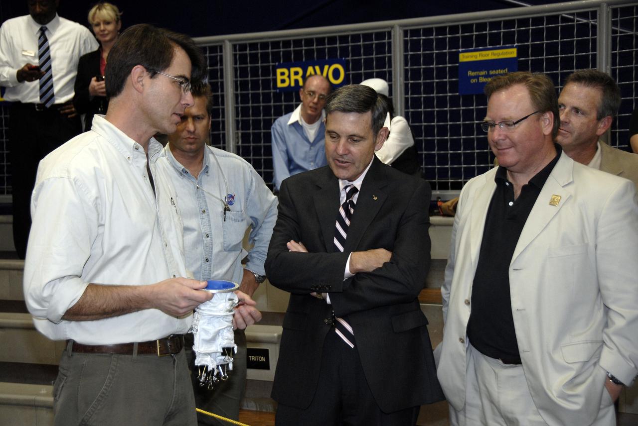 CAPE CANAVERAL, Fla. - At the Astronaut Hall of Fame near NASA’s Kennedy Space Center in Florida, first-prize winner Peter Homer, left, of Southwest Harbor, Maine, talks with Kennedy Director Bob Cabana and Doug Comstock, director of the NASA Innovative Partnerships Program, about his winning glove design in the 2009 Astronaut Glove Challenge, part of NASA’s Centennial Challenges Program.    The nationwide competition focused on developing improved pressure suit gloves for astronauts to use while working in space.  During the challenge, the gloves were submitted to burst tests, joint force tests and tests to measure their dexterity and strength during operation in a glove box which simulates the vacuum of space.  Centennial Challenges is NASA’s program of technology prizes for the citizen-inventor. The winning prize for the Glove Challenge is $250,000 provided by the Centennial Challenges Program.  Photo credit: NASA/Kim Shiflett