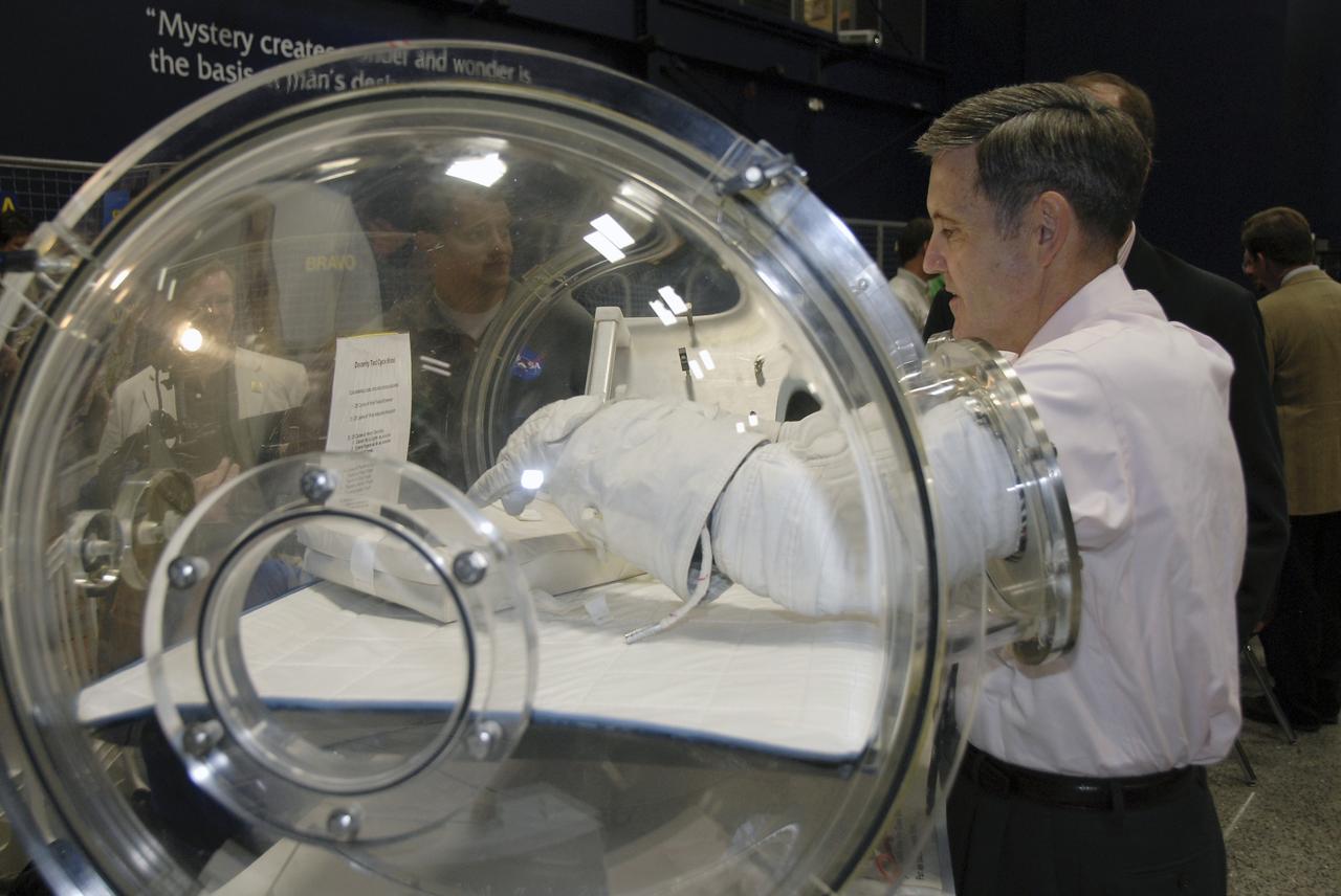 CAPE CANAVERAL, Fla. – At the Astronaut Hall of Fame near NASA’s Kennedy Space Center in Florida, Kennedy Director Bob Cabana, a former astronaut, tests a pair of space gloves for their dexterity and flexibility in a glove box  at the 2009 Astronaut Glove Challenge, part of NASA’s Centennial Challenges Program.    The nationwide competition focused on developing improved pressure suit gloves for astronauts to use while working in space.  During the challenge, the gloves were submitted to burst tests, joint force tests and tests to measure their dexterity and strength during operation in a glove box which simulates the vacuum of space.  Centennial Challenges is NASA’s program of technology prizes for the citizen-inventor. The winning prize for the Glove Challenge is $250,000 provided by the Centennial Challenges Program.  Photo credit: NASA/Kim Shiflett