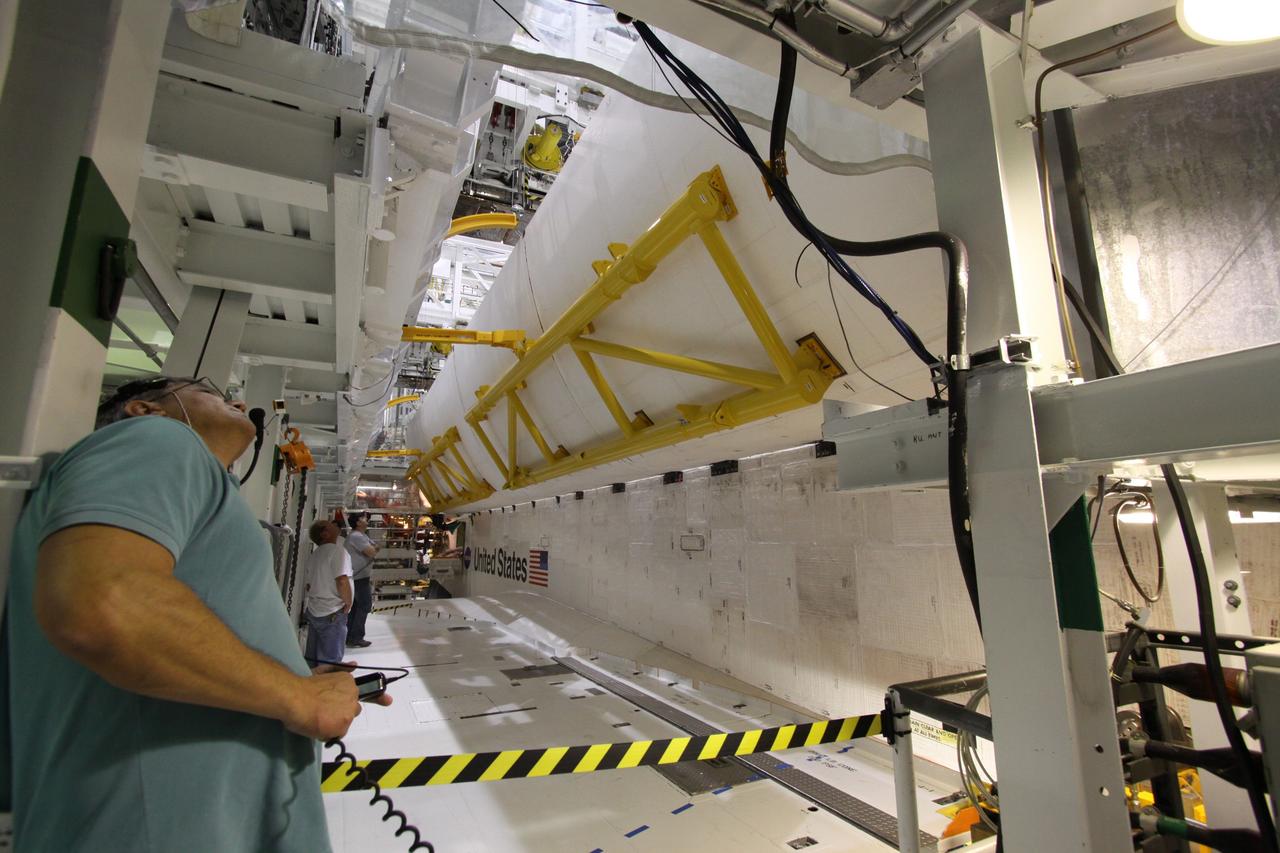 CAPE CANAVERAL, Fla. – In Orbiter Processing Facility-2 at NASA's Kennedy Space Center in Florida, workers begin to close space shuttle Endeavour's payload bay doors for the shuttle's upcoming move to the Vehicle Assembly Building. The move, or "rollover," is targeted for Dec. 12. The Tranquility module, the payload for Endeavour's STS-130 mission to the International Space Station, will be installed in the payload bay after the shuttle has reached the pad. Endeavour's launch is targeted for Feb. 4, 2010. For information on the STS-130 mission and crew, visit http://www.nasa.gov/mission_pages/shuttle/shuttlemissions/sts130/index.html. Photo credit: NASA/Jack Pfaller