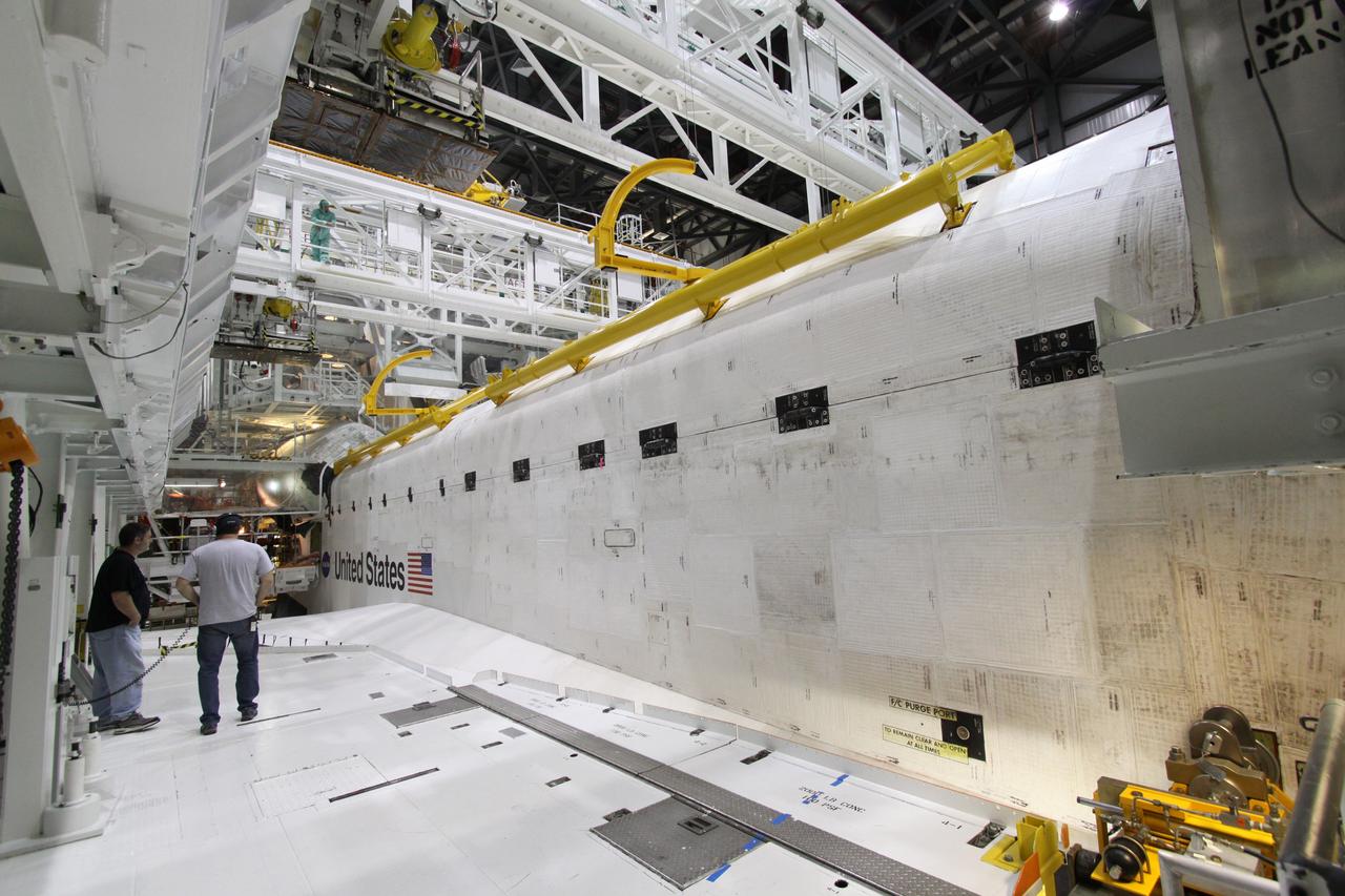 CAPE CANAVERAL, Fla. – In Orbiter Processing Facility-2 at NASA's Kennedy Space Center in Florida, workers secure space shuttle Endeavour's payload bay doors for the shuttle's upcoming move to the Vehicle Assembly Building. The move, or "rollover," is targeted for Dec. 12. The Tranquility module, the payload for Endeavour's STS-130 mission to the International Space Station, will be installed in the payload bay after the shuttle has reached the pad. Endeavour's launch is targeted for Feb. 4, 2010. For information on the STS-130 mission and crew, visit http://www.nasa.gov/mission_pages/shuttle/shuttlemissions/sts130/index.html. Photo credit: NASA/Jack Pfaller