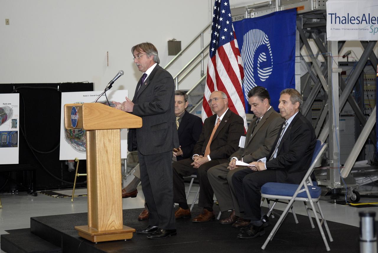 CAPE CANAVERAL, Fla. – In the Space Station Processing Facility at NASA's Kennedy Space Center in Florida, Secondino Brondolo, head of the Space Infrastructure, Thales Alenia Space Italy, addresses the invited guests at a ceremony transferring the ownership of node 3 for the International Space Station from the European Space Agency, or ESA, to NASA.  Seated, from left, are Bob Cabana, Kennedy Space Center director; Michael Suffredini, program manager, International Space Station, NASA; William Dowdell, deputy for Operations, International Space Station and Spacecraft Processing, Kennedy; and Bernardo Patti, head of International Space Station, Program Department, ESA.    Node 3 is named "Tranquility" after the Sea of Tranquility, the lunar landing site of Apollo 11.  The payload for the STS-130 mission, Tranquility is a pressurized module that will provide room for many of the International Space Station's life support systems. The module was built for ESA by Thales Alenia Space in Turin, Italy. Attached to one end of Tranquility is a cupola, a unique work station with six windows on its sides and one on top.  The cupola resembles a circular bay window and will provide a vastly improved view of the station's exterior. Just under 10 feet in diameter, the module will accommodate two crew members and portable workstations that can control station and robotic activities. The multi-directional view will allow the crew to monitor spacewalks and docking operations, as well as provide a spectacular view of Earth and other celestial objects. Space shuttle Endeavour's STS-130 mission is targeted to launch Feb. 4, 2010. Photo credit: NASA/Kim Shiflett