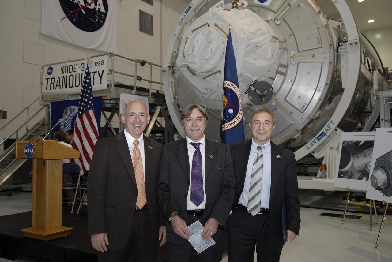 CAPE CANAVERAL, Fla. – In the Space Station Processing Facility at NASA's Kennedy Space Center in Florida, from left, Michael Suffredini, program manager, International Space Station, NASA; Secondino Brondolo, head of the Space Infrastructure, Thales Alenia Space Italy; and Bernardo Patti, head of International Space Station, Program Department, ESA, are photographed in front of node 3 for the International Space Station following a ceremony transferring the ownership of the node from the European Space Agency, or ESA, to NASA.    Node 3 is named "Tranquility" after the Sea of Tranquility, the lunar landing site of Apollo 11.  The payload for the STS-130 mission, Tranquility is a pressurized module that will provide room for many of the International Space Station's life support systems. The module was built for ESA by Thales Alenia Space in Turin, Italy. Attached to one end of Tranquility is a cupola, a unique work station with six windows on its sides and one on top.  The cupola resembles a circular bay window and will provide a vastly improved view of the station's exterior. Just under 10 feet in diameter, the module will accommodate two crew members and portable workstations that can control station and robotic activities. The multi-directional view will allow the crew to monitor spacewalks and docking operations, as well as provide a spectacular view of Earth and other celestial objects. Space shuttle Endeavour's STS-130 mission is targeted to launch Feb. 4, 2010. Photo credit: NASA/Kim Shiflett
