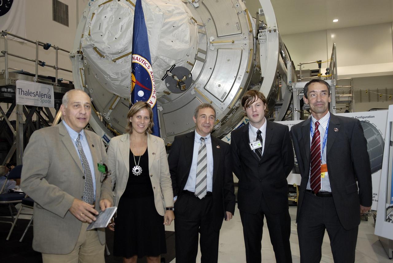 CAPE CANAVERAL, Fla. – In the Space Station Processing Facility at NASA's Kennedy Space Center in Florida, Bernardo Patti, head of International Space Station, Program Department, European Space Agency, or ESA, is photographed with invited guests of ESA in front of node 3 for the International Space Station following a ceremony transferring the ownership of the node from ESA to NASA.    Node 3 is named "Tranquility" after the Sea of Tranquility, the lunar landing site of Apollo 11.  The payload for the STS-130 mission, Tranquility is a pressurized module that will provide room for many of the International Space Station's life support systems. The module was built for ESA by Thales Alenia Space in Turin, Italy. Attached to one end of Tranquility is a cupola, a unique work station with six windows on its sides and one on top.  The cupola resembles a circular bay window and will provide a vastly improved view of the station's exterior. Just under 10 feet in diameter, the module will accommodate two crew members and portable workstations that can control station and robotic activities. The multi-directional view will allow the crew to monitor spacewalks and docking operations, as well as provide a spectacular view of Earth and other celestial objects. Space shuttle Endeavour's STS-130 mission is targeted to launch Feb. 4, 2010. Photo credit: NASA/Kim Shiflett