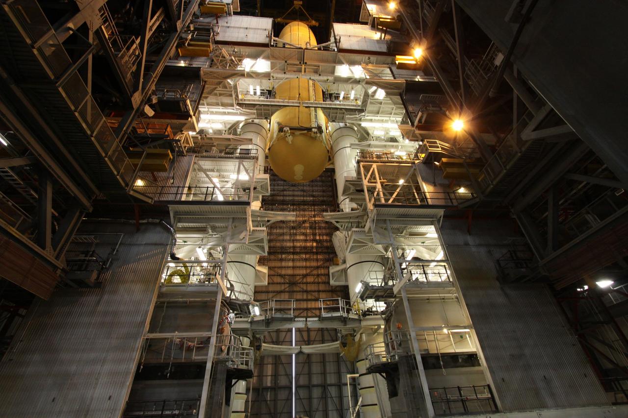 CAPE CANAVERAL, Fla. – In the Vehicle Assembly Building at NASA's Kennedy Space Center in Florida, the external tank for space shuttle Endeavour's STS-130 mission, ET-134, is lowered toward the twin solid rocket boosters already stacked on a mobile launcher platform in High Bay-1 for use on the mission. Endeavour's move, or "rollover," from Orbiter Processing Facility-2 is targeted for Dec. 12. The Tranquility module, the payload for the STS-130 mission to the International Space Station, will be installed in the payload bay after the shuttle has reached the pad. Endeavour's launch is targeted for Feb. 4, 2010. For information on the STS-130 mission and crew, visit http://www.nasa.gov/mission_pages/shuttle/shuttlemissions/sts130/index.html. Photo credit: NASA/Jack Pfaller