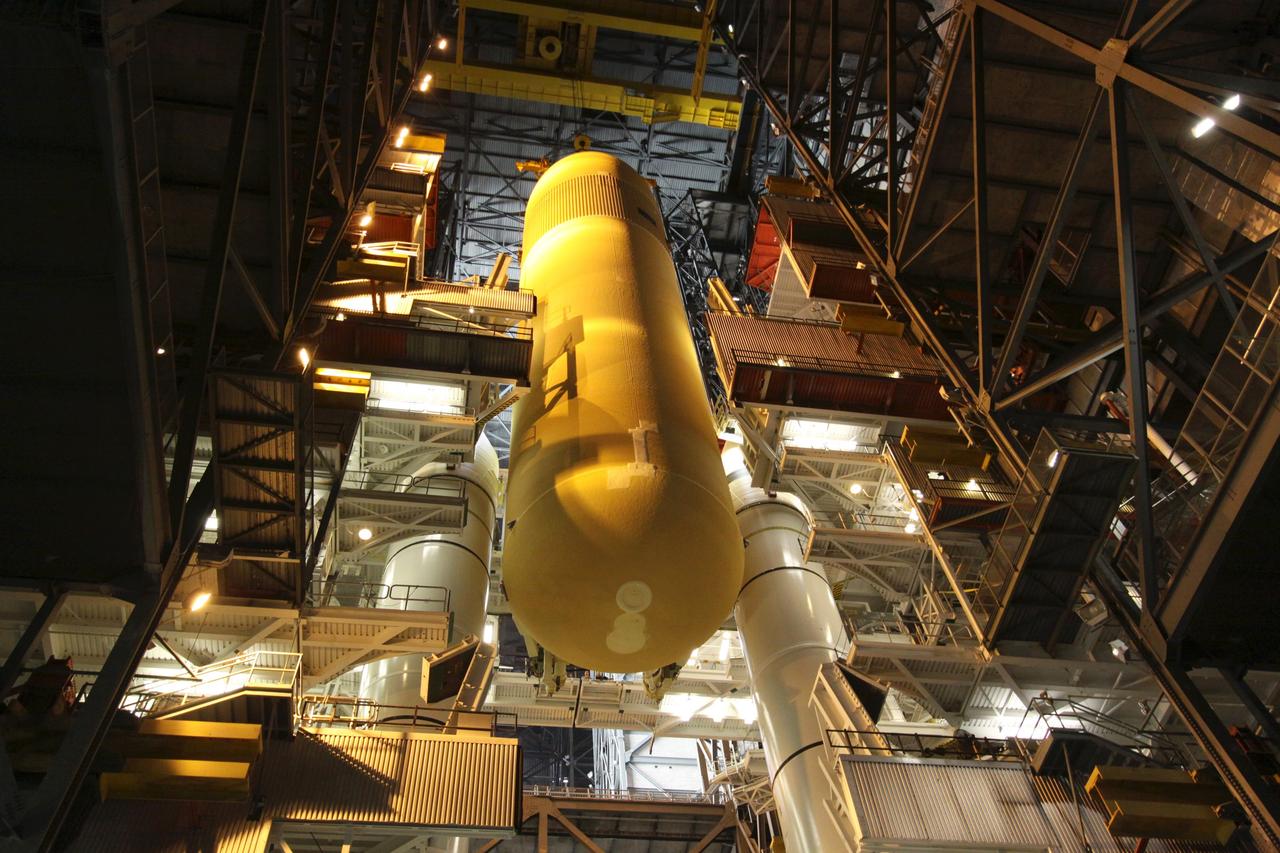 CAPE CANAVERAL, Fla. – In the Vehicle Assembly Building at NASA's Kennedy Space Center in Florida, the external tank for space shuttle Endeavour's STS-130 mission, ET-134, is lowered between the twin solid rocket boosters already stacked on a mobile launcher platform in High Bay-1 for use on the mission. Endeavour's move, or "rollover," from Orbiter Processing Facility-2 is targeted for Dec. 12. The Tranquility module, the payload for the STS-130 mission to the International Space Station, will be installed in the payload bay after the shuttle has reached the pad. Endeavour's launch is targeted for Feb. 4, 2010. For information on the STS-130 mission and crew, visit http://www.nasa.gov/mission_pages/shuttle/shuttlemissions/sts130/index.html. Photo credit: NASA/Jack Pfaller