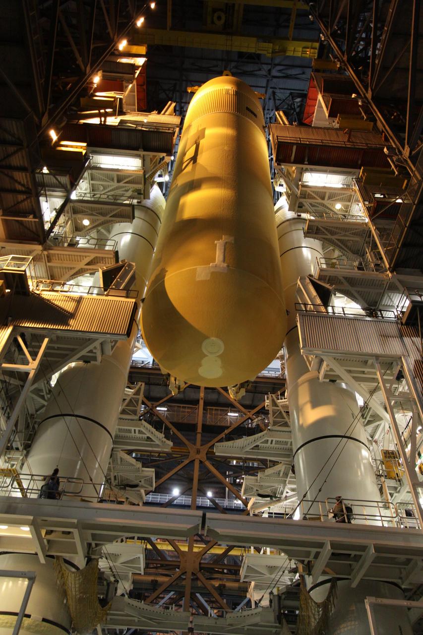CAPE CANAVERAL, Fla. – In the Vehicle Assembly Building at NASA's Kennedy Space Center in Florida, the external tank for space shuttle Endeavour's STS-130 mission, ET-134, is lowered beside the twin solid rocket boosters already stacked on a mobile launcher platform in High Bay-1 for use on the mission. Endeavour's move, or "rollover," from Orbiter Processing Facility-2 is targeted for Dec. 12. The Tranquility module, the payload for the STS-130 mission to the International Space Station, will be installed in the payload bay after the shuttle has reached the pad. Endeavour's launch is targeted for Feb. 4, 2010. For information on the STS-130 mission and crew, visit http://www.nasa.gov/mission_pages/shuttle/shuttlemissions/sts130/index.html. Photo credit: NASA/Jack Pfaller