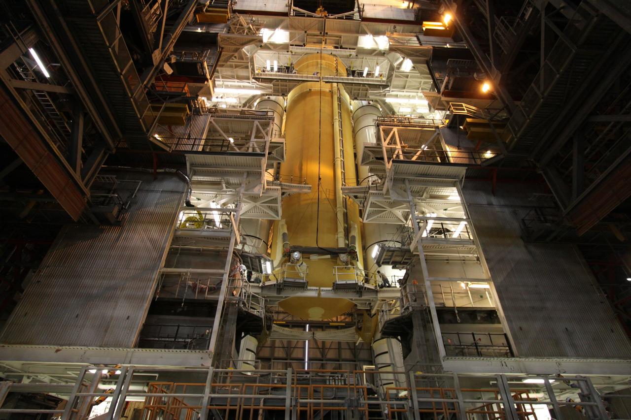 CAPE CANAVERAL, Fla. – In the Vehicle Assembly Building at NASA's Kennedy Space Center in Florida, the external tank for space shuttle Endeavour's STS-130 mission, ET-134, is positioned beside the twin solid rocket boosters already stacked on a mobile launcher platform in High Bay-1 and ready to be mated. Endeavour's move, or "rollover," from Orbiter Processing Facility-2 is targeted for Dec. 12. The Tranquility module, the payload for the STS-130 mission to the International Space Station, will be installed in the payload bay after the shuttle has reached the pad. Endeavour's launch is targeted for Feb. 4, 2010. For information on the STS-130 mission and crew, visit http://www.nasa.gov/mission_pages/shuttle/shuttlemissions/sts130/index.html. Photo credit: NASA/Jack Pfaller