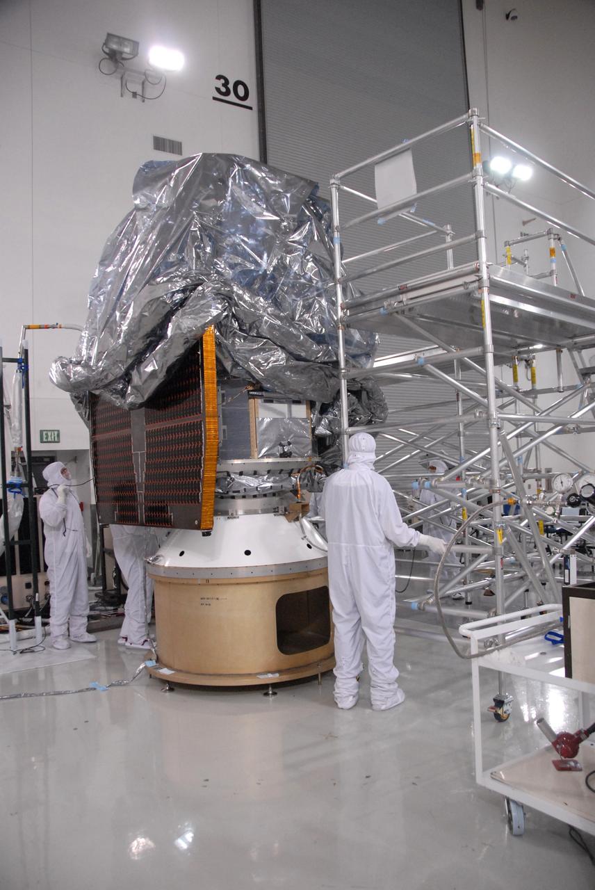 VANDENBERG AIR FORCE BASE, Calif. - At the Astrotech payload processing facility at Vandenberg Air Force Base in California, spacecraft technicians carefully lower an environmental covering over NASA's Wide-field Infrared Survey Explorer, or WISE, to protect it from contamination during its move to Space Launch Complex 2. WISE will survey the entire sky at infrared wavelengths, creating a cosmic clearinghouse of hundreds of millions of objects which will be catalogued and provide a vast storehouse of knowledge about the solar system, the Milky Way, and the universe. Launch aboard a United Launch Alliance Delta II rocket is scheduled for Dec. 9. For additional information, visit http://www.nasa.gov/wise. Photo credit: NASA