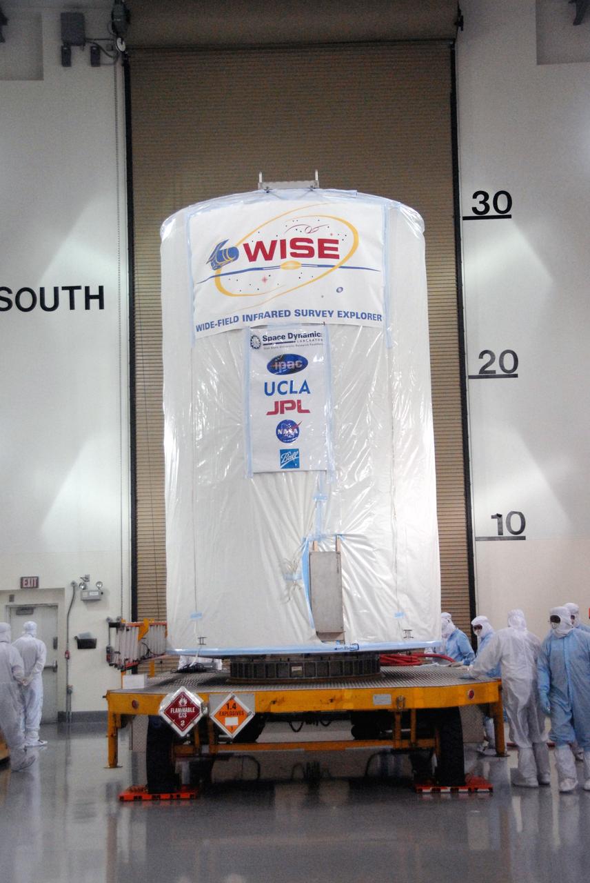 VANDENBERG AIR FORCE BASE, Calif. - At the Astrotech payload processing facility at Vandenberg Air Force Base in California, a transportation canister containing NASA's Wide-field Infrared Survey Explorer, or WISE, is secured on the transporter which will move it to Space Launch Complex 2. WISE will survey the entire sky at infrared wavelengths, creating a cosmic clearinghouse of hundreds of millions of objects which will be catalogued and provide a vast storehouse of knowledge about the solar system, the Milky Way, and the universe. Launch aboard a United Launch Alliance Delta II rocket is scheduled for Dec. 9. For additional information, visit http://www.nasa.gov/wise. Photo credit: NASA/Daniel Liberotti, VAFB
